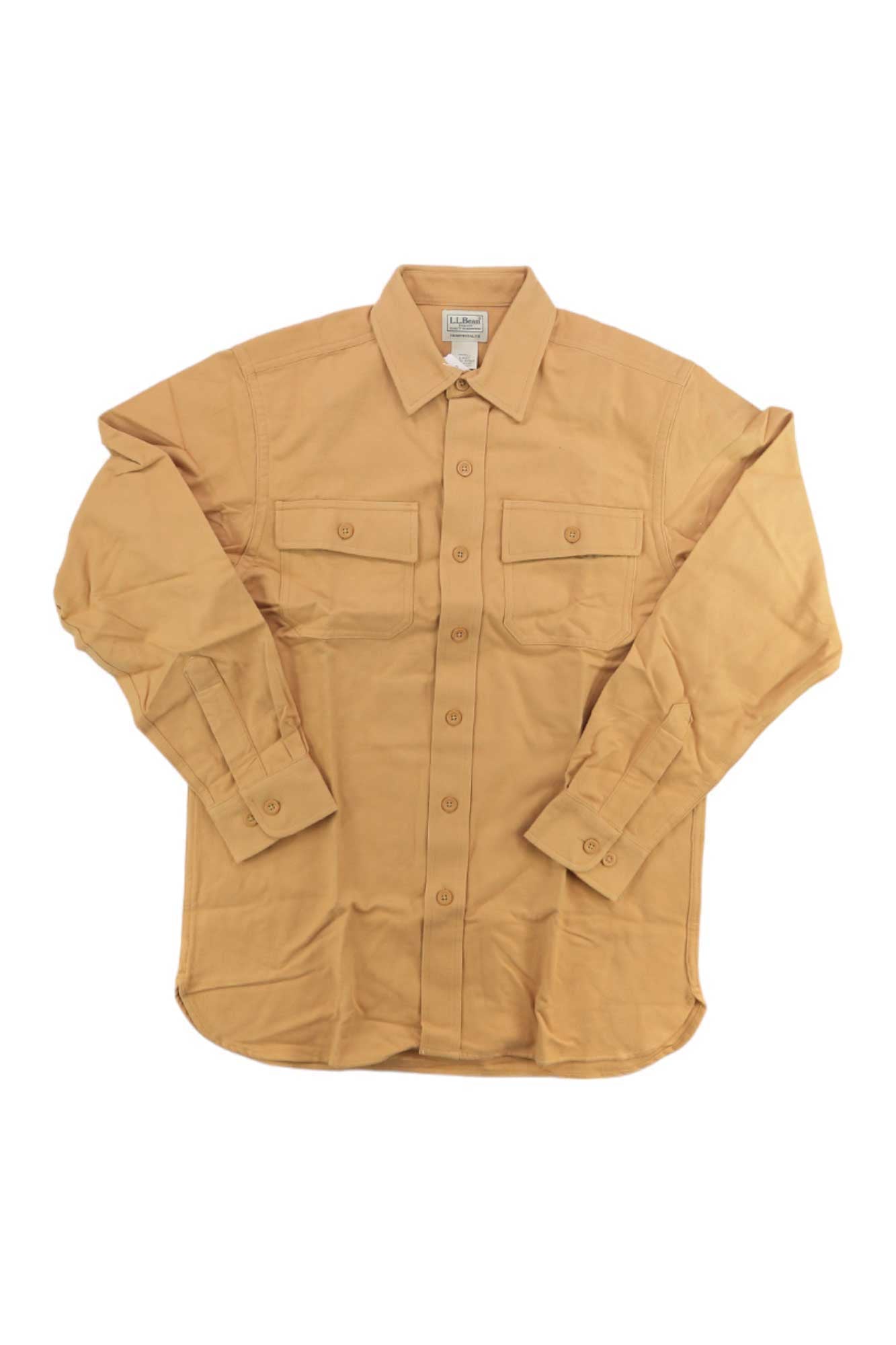 L.L.Bean Men's Chamois Shirt in tan, long-sleeve with two chest pockets and buttoned cuffs, features unbreakable buttons for lasting durability. Shirt is shown laid flat on a white background.