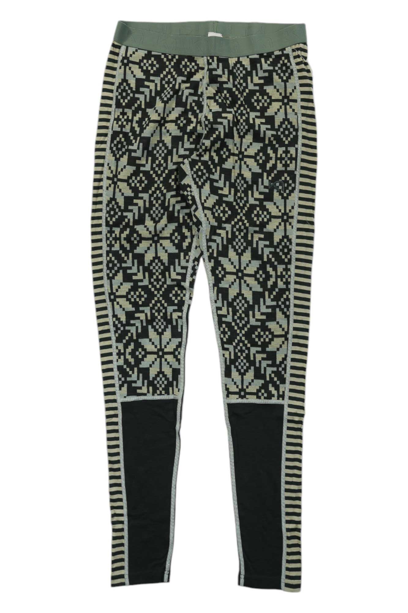 The Kari Traa Womens Else Pant features an intricate black and beige geometric snowflake pattern, striped side panels, solid black knee patches, and moisture-wicking fabric for comfort during active outdoor adventures.