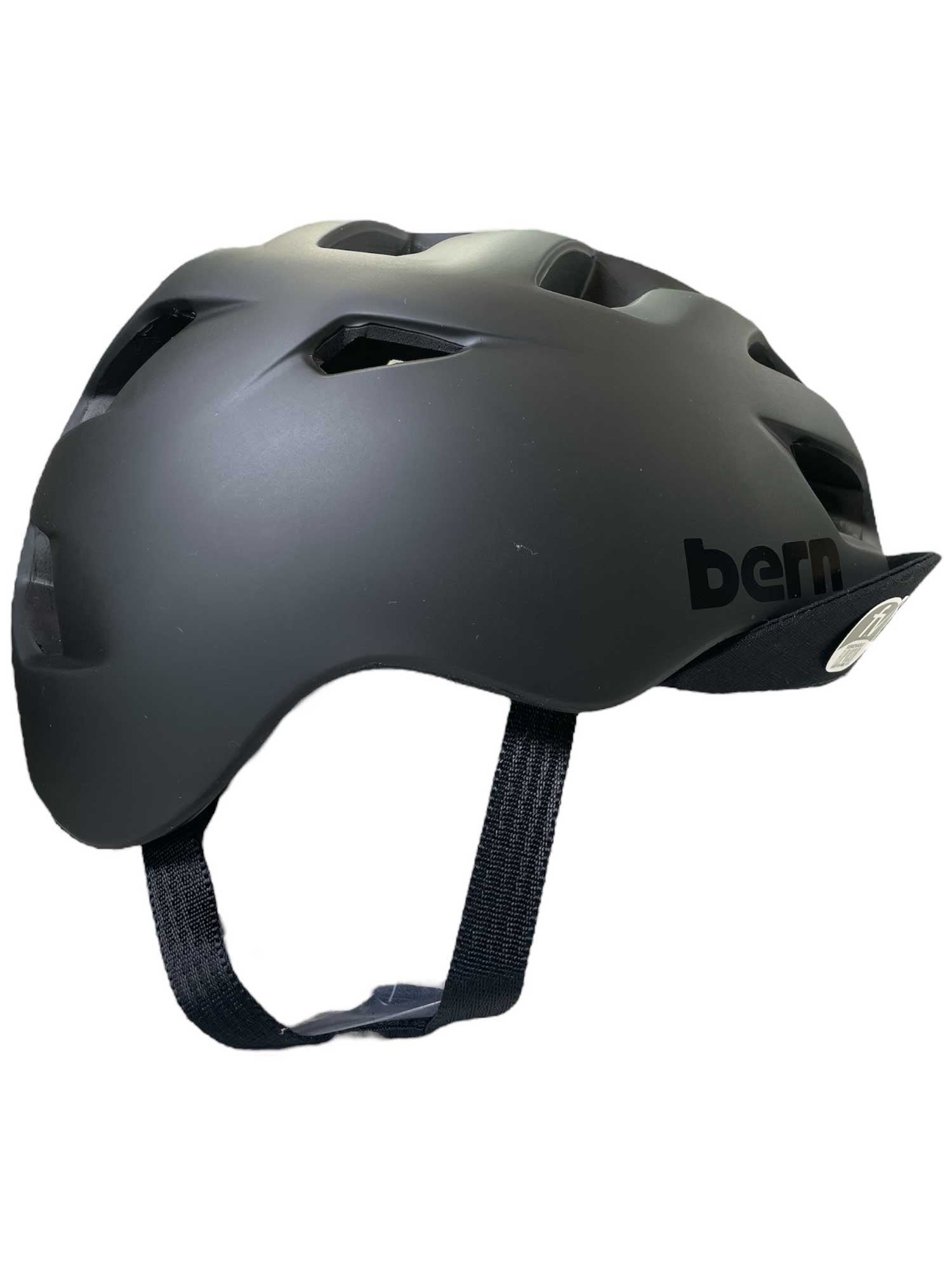 The Bern Mens Allston Helmet is a matte black ventilated bike helmet with airflow holes, black adjustable straps, and the bern logo on the side, displayed from a side view against a white background.
