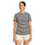 A woman stands against a plain white background, wearing The North Face Womens Best Tee Ever in black and white stripes—a women's slim fit t-shirt made from organic cotton—paired with light shorts. Her dark hair is pulled back as she looks slightly to the side.