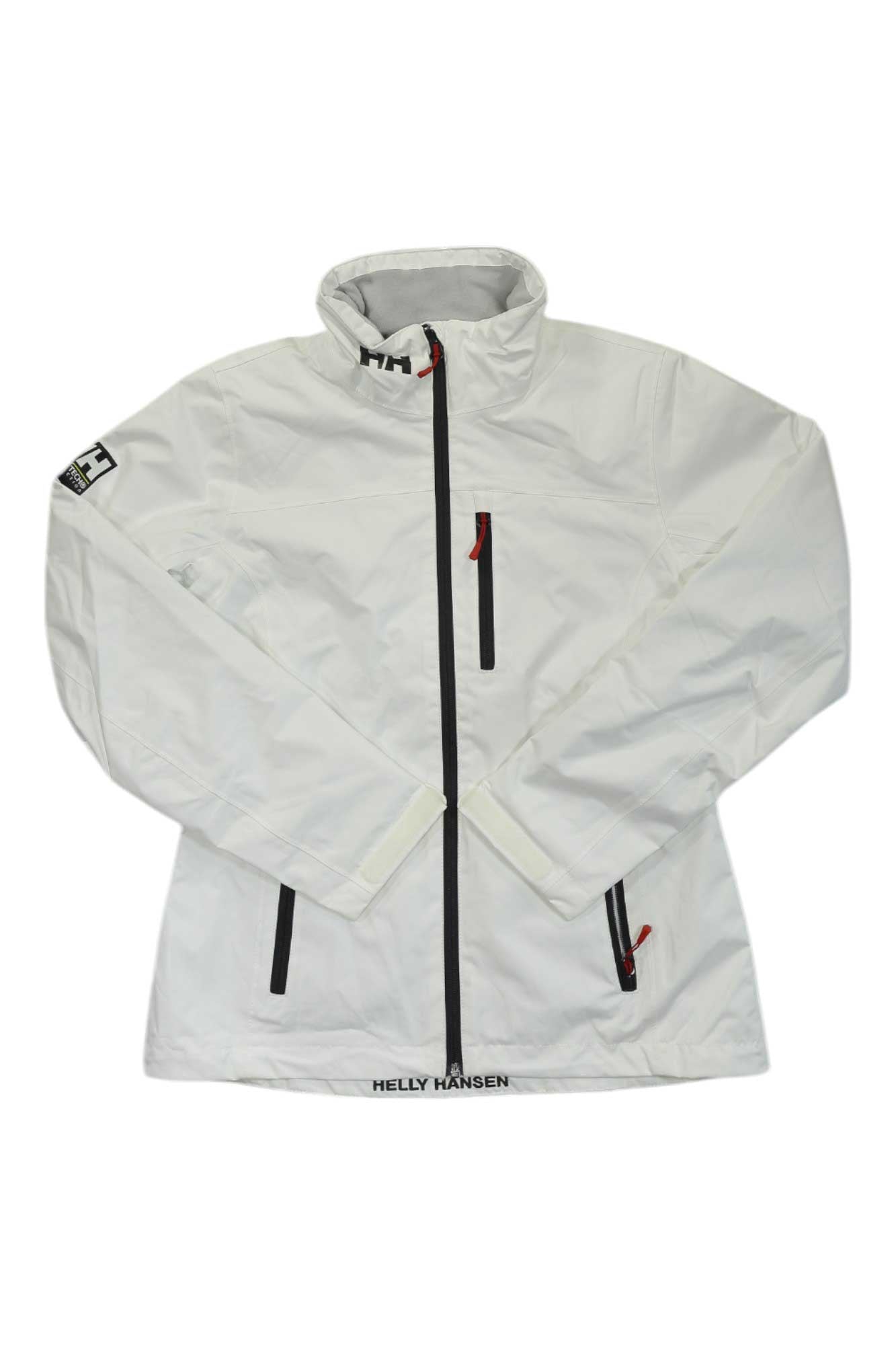 The Helly Hansen Womens Crew Midlayer Jacket is a white jacket with a high collar, black zippers, bold red zipper accents, the Helly Hansen name at the lower front, and a logo patch on the upper left sleeve.