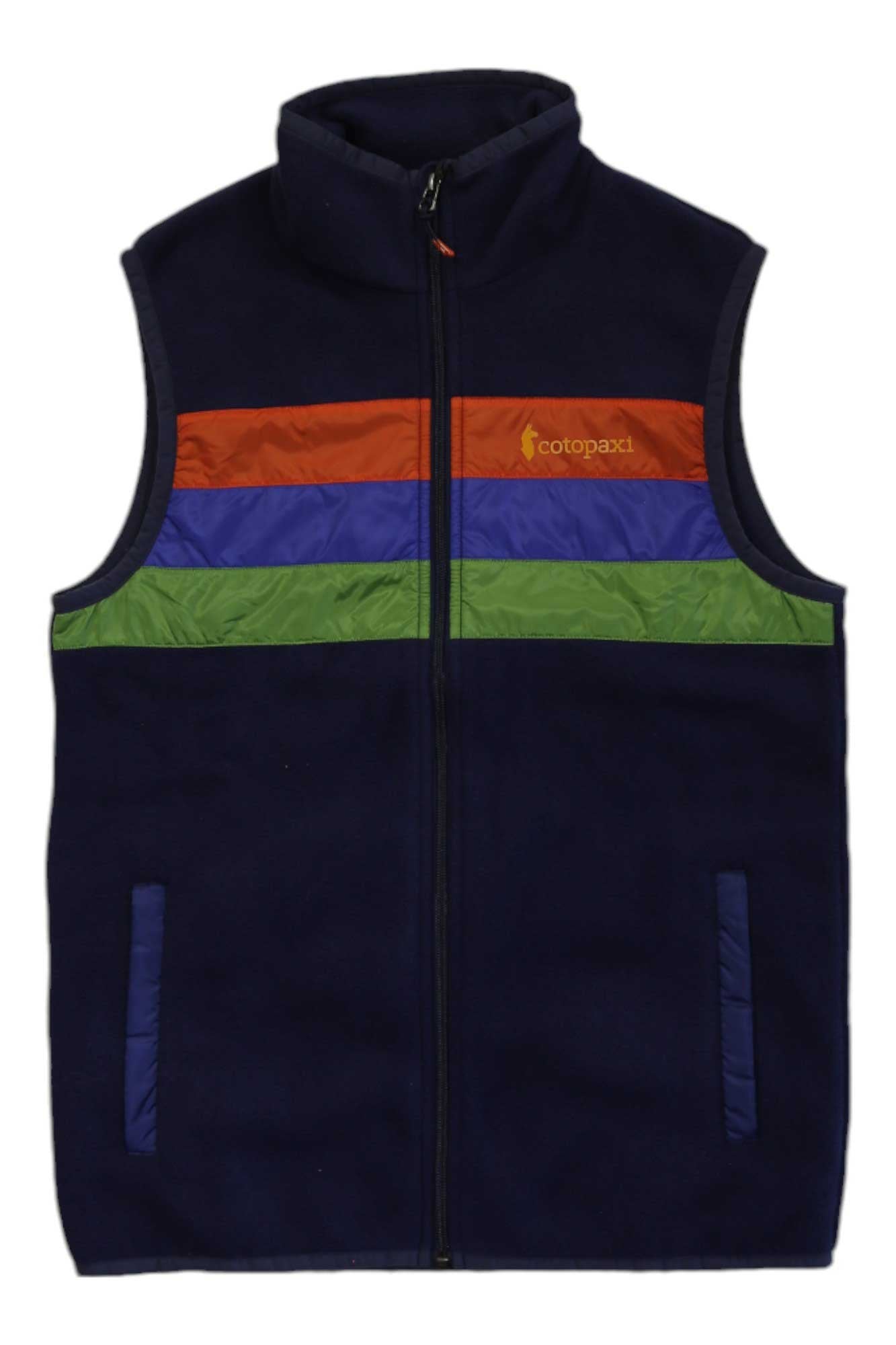 The Cotopaxi Teca Fleece Vest is navy blue with a front zipper, horizontal orange, blue, and green chest stripes, two side pockets, the Cotopaxi logo on the left, and is made from recycled materials.