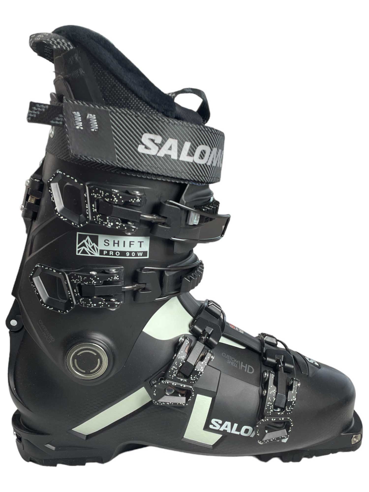 Salomon ski boot black cuff with strap, metal buckles, and light panel on instep