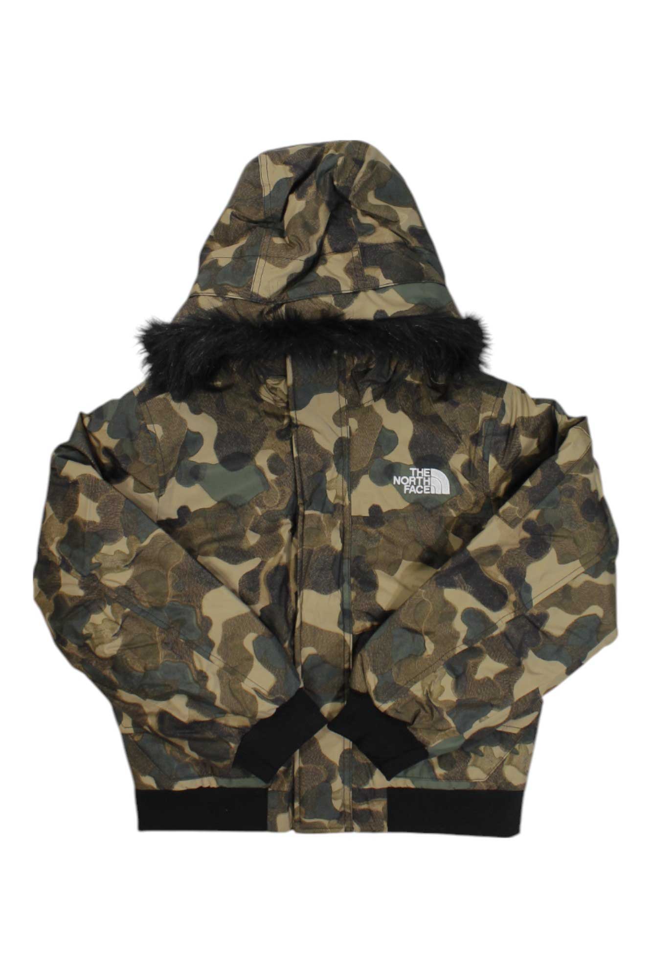 The North Face Boys Gotham Jacket features a camouflage pattern, black fur-trimmed hood, and black cuffs—ideal as a boys' insulated winter jacket. Displayed against a white background.