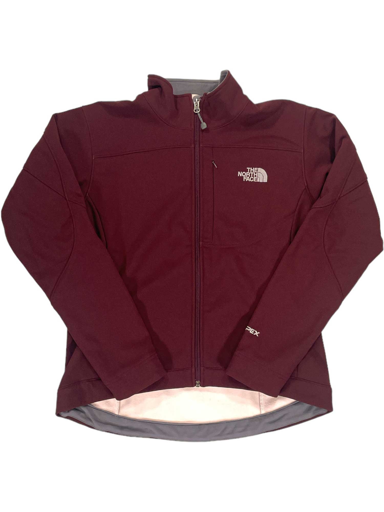A maroon The North Face Apex Bionic Jacket for men, featuring a front zipper, chest pocket, left-chest logo, slightly longer back hem, and simple cuffs and collar.