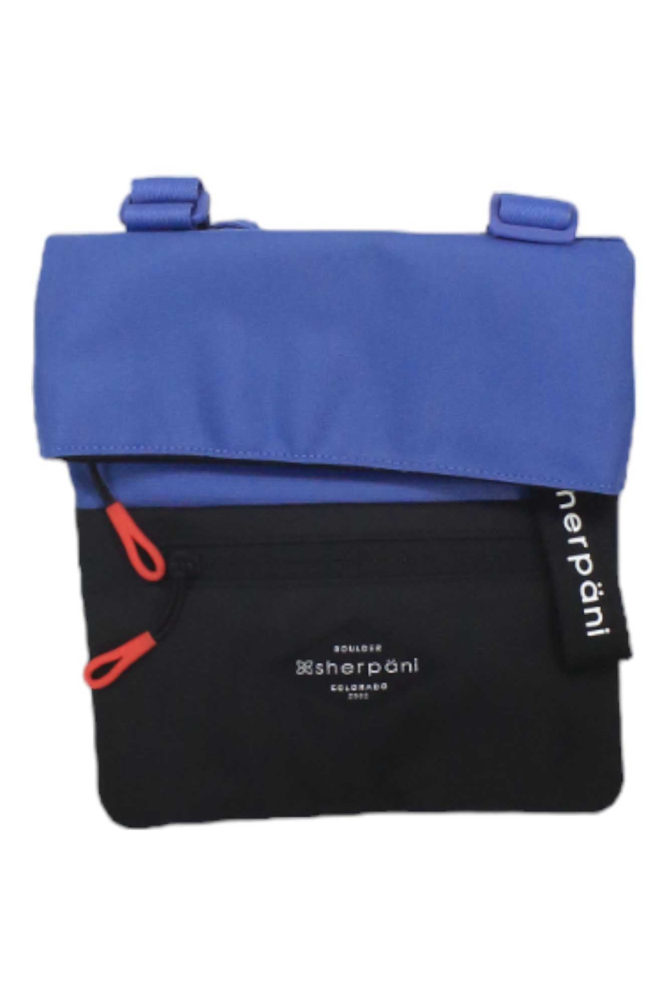 The Sherpani Womens Pica Cross Body Bag features a blue flap, black body, front zipper pocket with red pull tabs, RFID-protected pocket, and a white "sherpani" label.