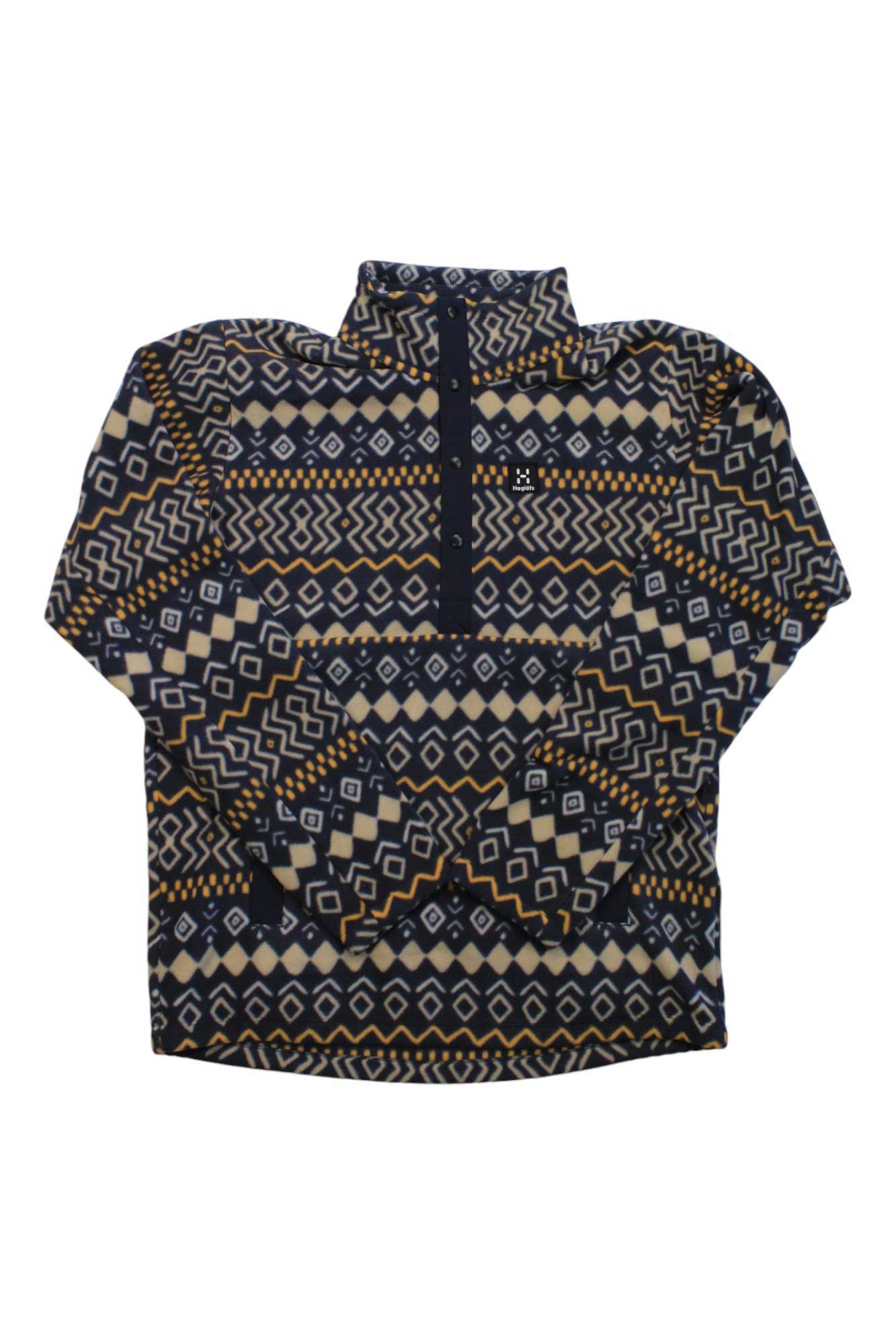The Haglofs Mens Mora Midlayer Top is a navy long-sleeve fleece pullover with a quarter zip, high collar, and white and tan geometric patterns, made from recycled polyester.