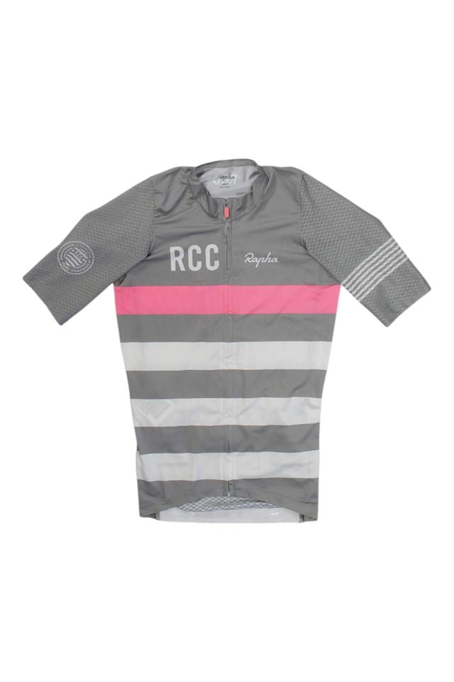 The Pro Team Aero Jersey II is a short-sleeved, zip-up cycling jersey in grey with light pink and white stripes, RCC and Rapha logos on the chest, and a circular emblem on the left sleeve, shown against a white background.