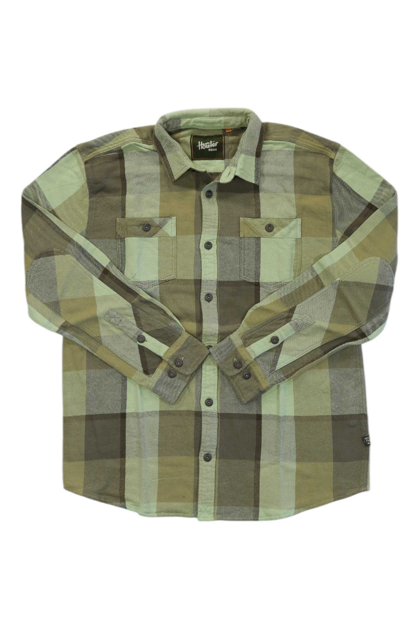 The Howler Brothers Mens Rodanthe Flannel Shirt, a heavyweight cotton flannel in green and brown with long sleeves, button-up front, two chest pockets, and buttoned cuffs, is laid flat on a white background.