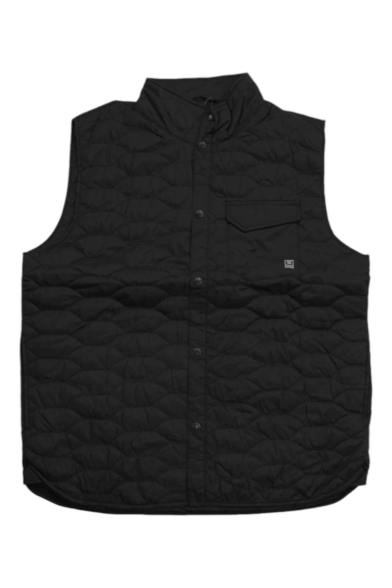 The Huk Men's Tarpon Quilt Vest is a sleeveless black insulated vest with a snap-button front, chest flap pocket, small square logo patch on the left chest, water-repellent finish, high collar, and a slightly curved hem for comfort.
