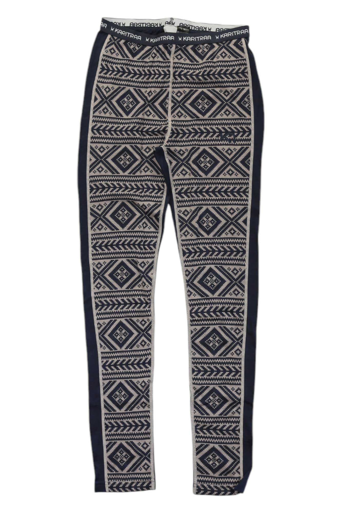 The Kari Traa Womens Floke Pant is a pair of patterned thermal leggings crafted from a soft wool-modal blend, featuring a black and white geometric design, navy side panels, and an elastic waistband with the white Kari Traa logo.