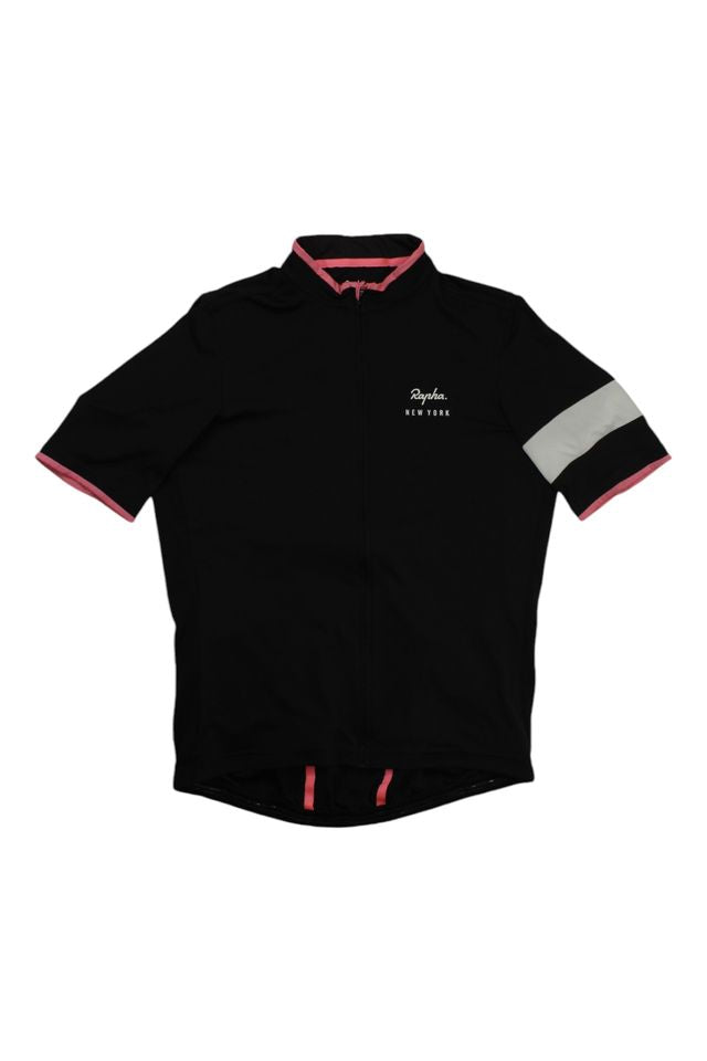 The Rapha Mens Super Lightweight Jersey is a black short-sleeve cycling jersey with pink trim, a white horizontal stripe on the left sleeve, and "Rapha New York" text on the chest, shown on a white background.