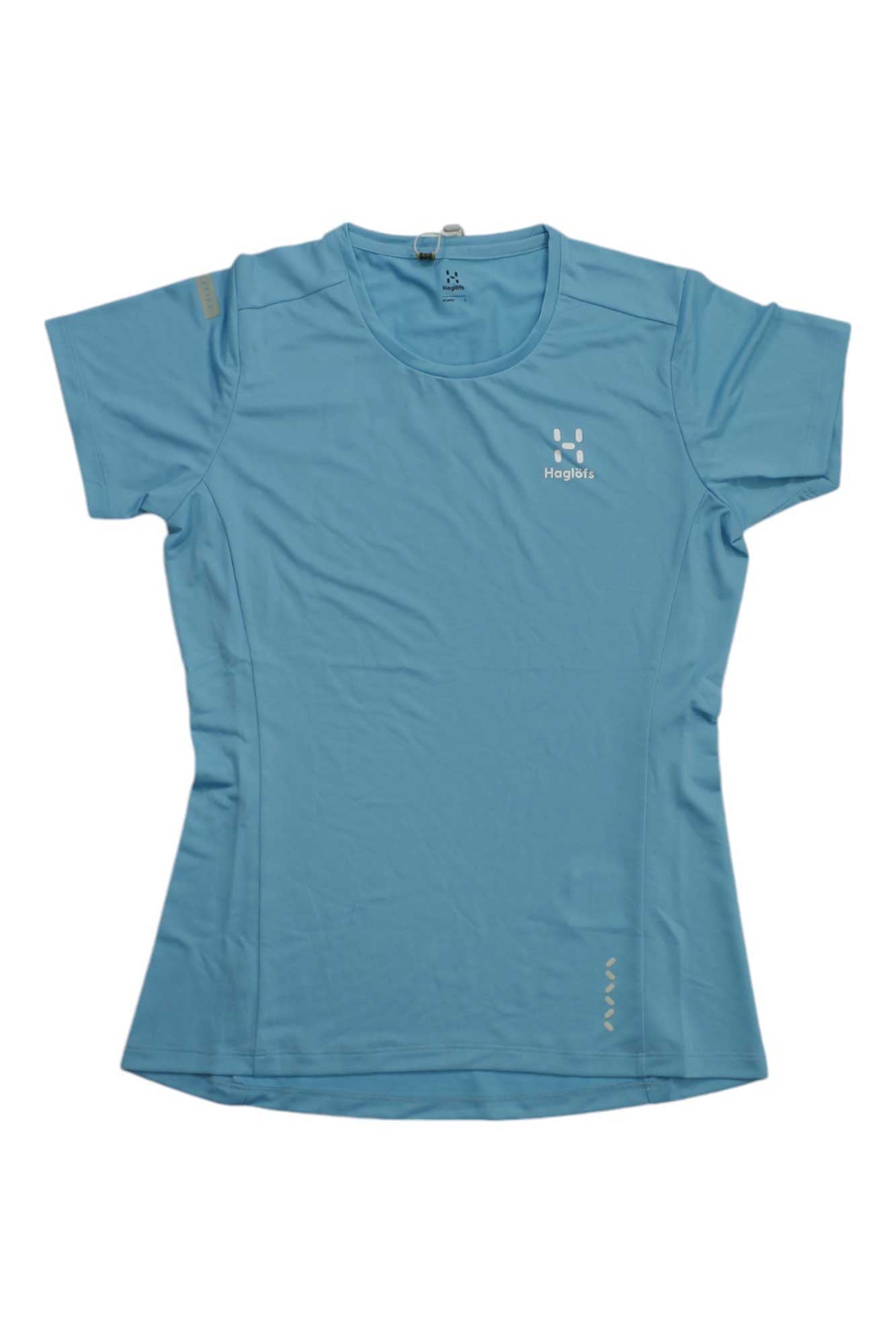 The Haglofs Womens L.I.M Tech Tee is a light blue, short-sleeve hiking shirt with a fitted shape and crew neck. Made from lightweight, moisture-wicking recycled polyester, it features a small white Haglöfs logo on the left chest.
