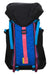 The Topo Designs Mountain 16L Pack features a black top flap, blue front panel, blue and purple straps, a bright pink center buckle strap, and a laptop sleeve—ideal as a hiking backpack or for daily essentials.