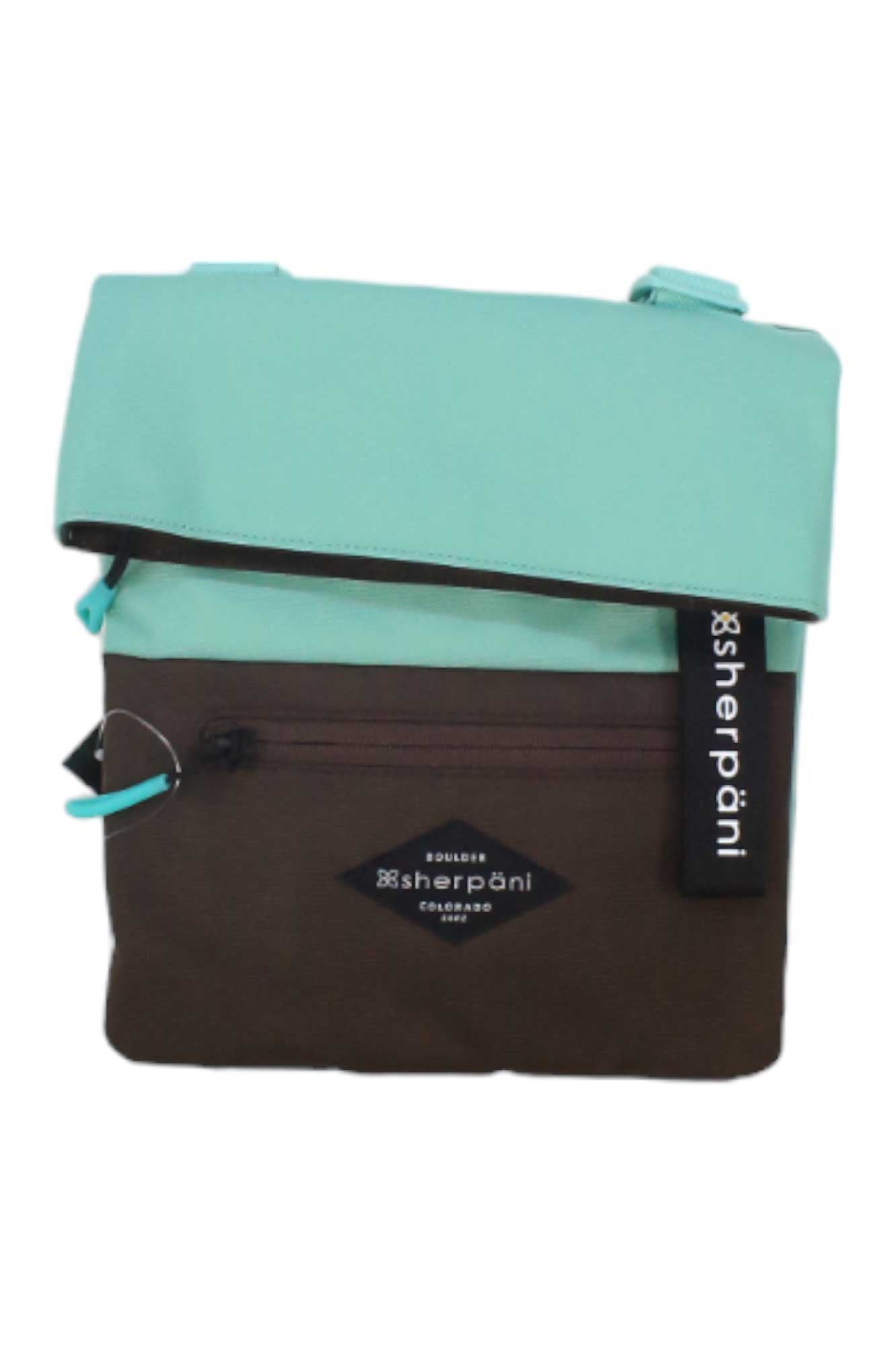 The Sherpani Womens Pica Cross Body Bag features a brown body, light blue flap, front zipper pocket with RFID protection, and a black Sherpani tag. Made from recycled materials for style and sustainability.