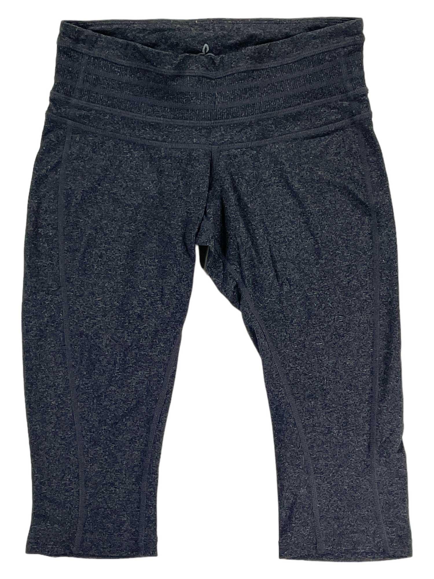 A pair of Womens Capri Leggings in dark gray with a wide waistband and subtle seams, shown laid flat on white—ideal for performance and your next hiking trail adventure.