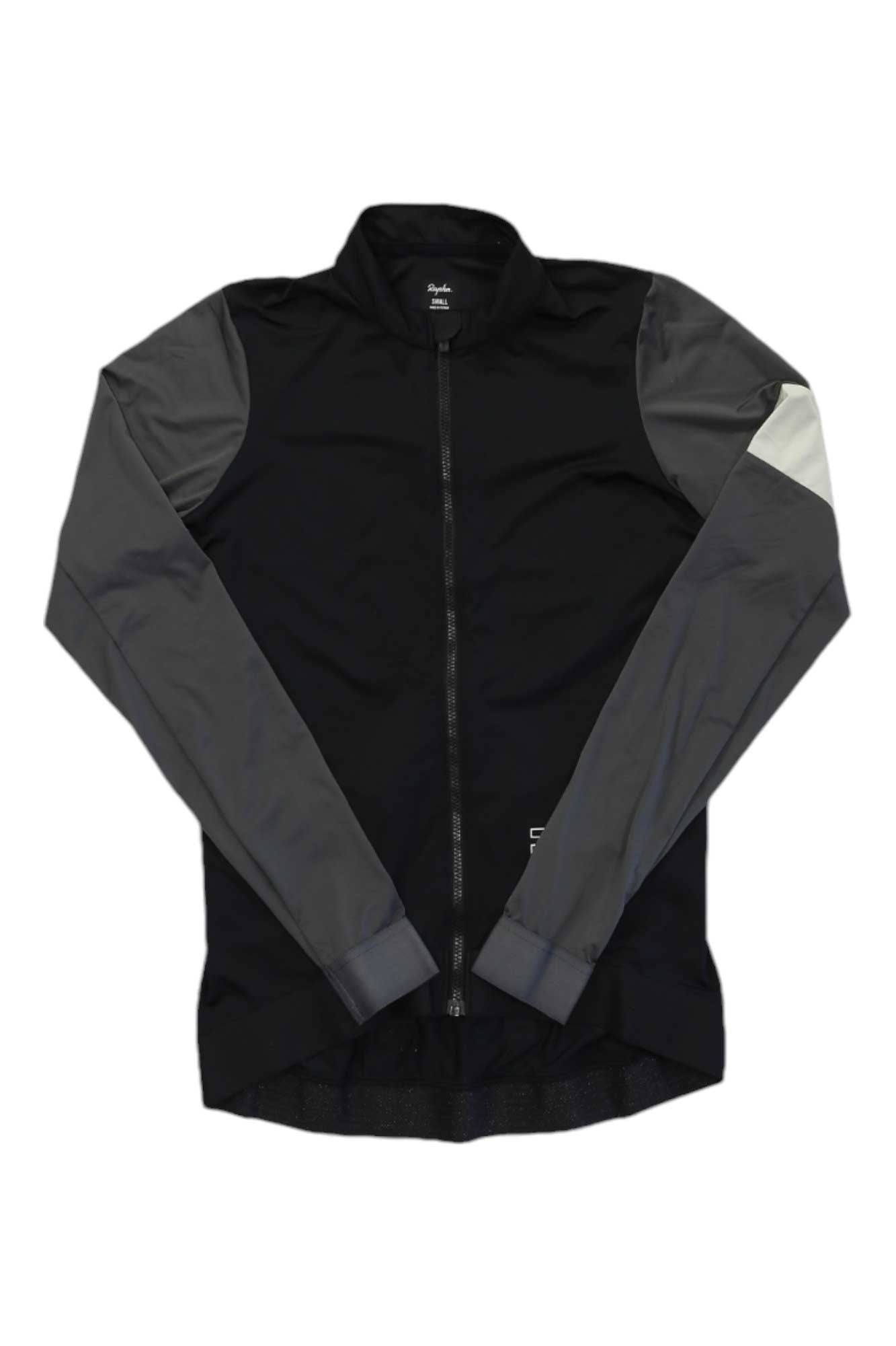 The Rapha Women's Pro Team Long Sleeve Training Jersey features a black body, dark gray sleeves, and a light gray patch on the upper left sleeve, perfect for training rides. Shown flat on a white background.