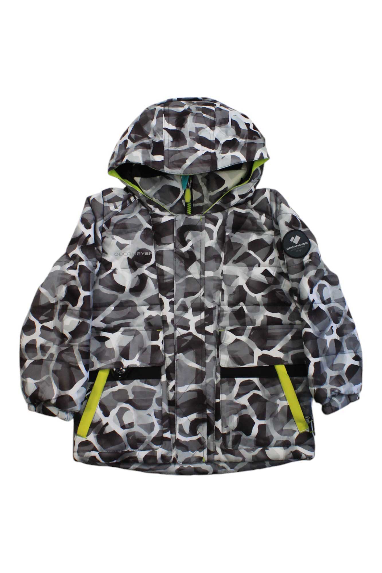 The Obermeyer Boys M-Way Jacket is an insulated ski jacket with HydroBlock Sport fabric, black/white/gray camo design, front zipper, two black zippered pockets with yellow trim, and a left sleeve patch.