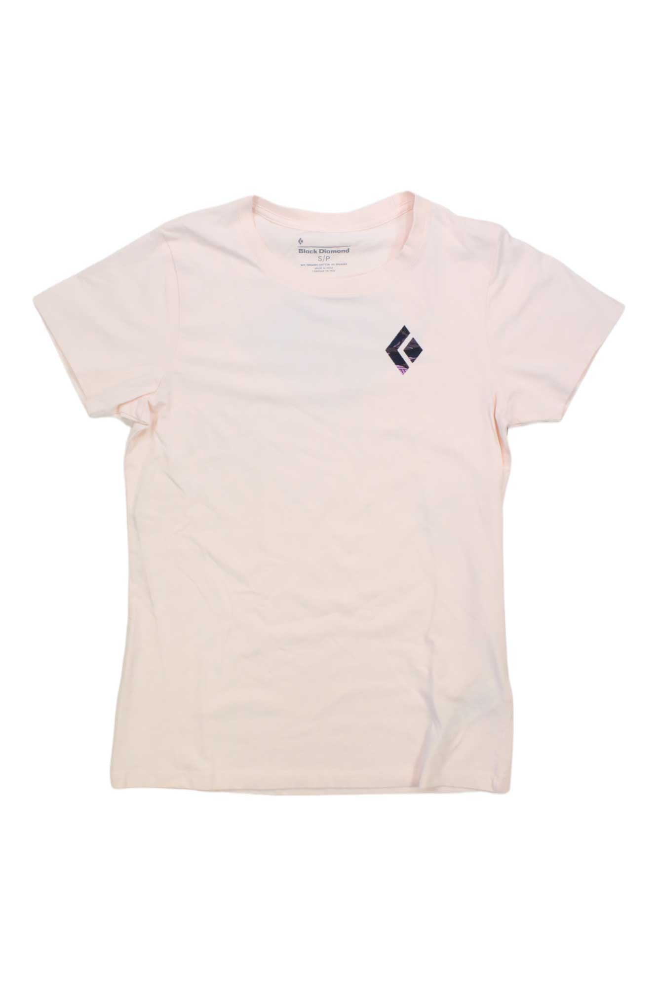 The Black Diamond Women's Mountain Diamond Tee is a plain light pink organic cotton short-sleeve shirt with a small black geometric logo on the upper left chest, shown laid flat on a white background.