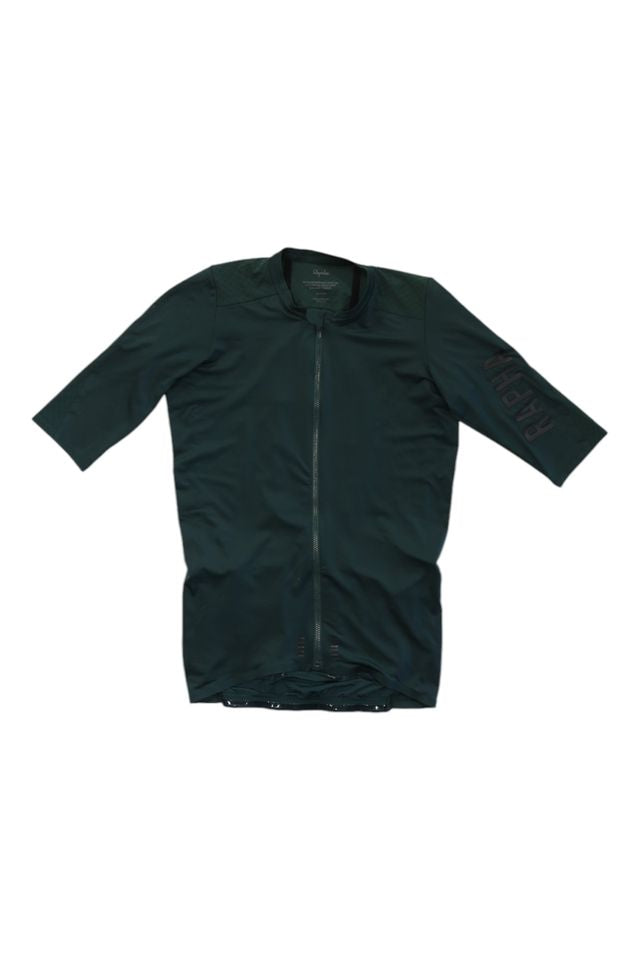 The Pro Team Aero Jersey II is a dark green cycling jersey with short sleeves, a front zipper, slightly longer sleeves, and RAPHA in large letters on the left sleeve.