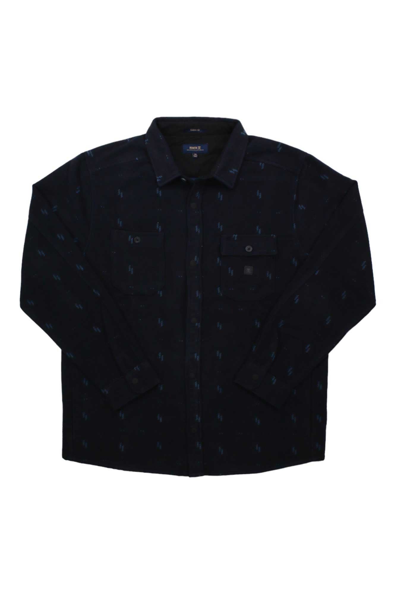 The Roark Men's Andes Shirt is a heavyweight black flannel overshirt with long sleeves, two chest pockets, and subtle blue patterns, shown laid flat on a white background.