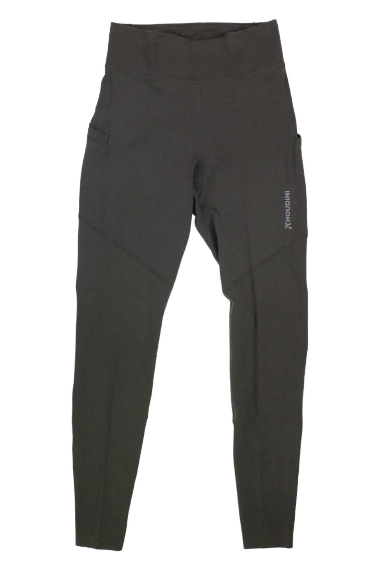 The Houdini Womens Adventure Tight is a high-waisted, dark gray legging with side pockets, visible seam details, and moisture-wicking fabric—ideal for any adventure. Shown flat against a white background.
