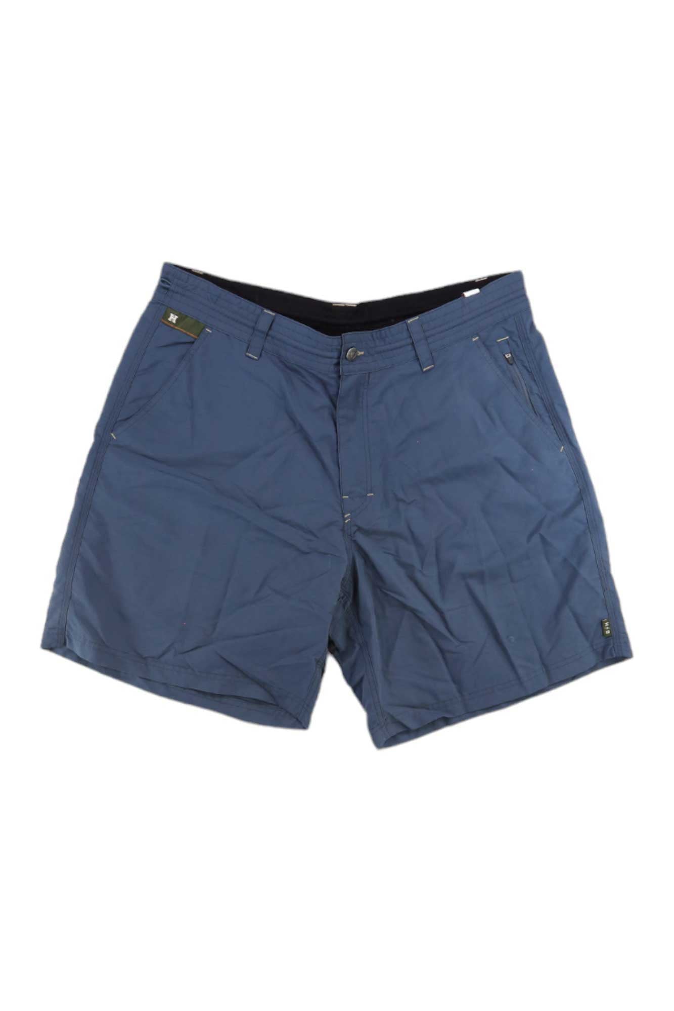 The Howler Brothers Men's Horizon Hybrid 2.0 7.5 Inch Short features blue, knee-length design with front pockets, button and zipper closure, belt loops, and lightweight quick-dry fabric—ideal for casual wear or fishing.