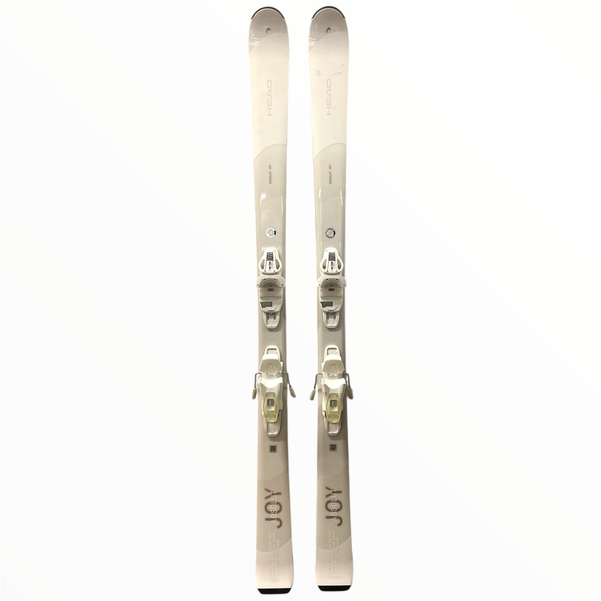 A pair of Head Womens Absolut Joy Skis with Joy 9 GW Bindings 2025 stands upright side by side on a plain white background, highlighting these sleek all-mountain skis.