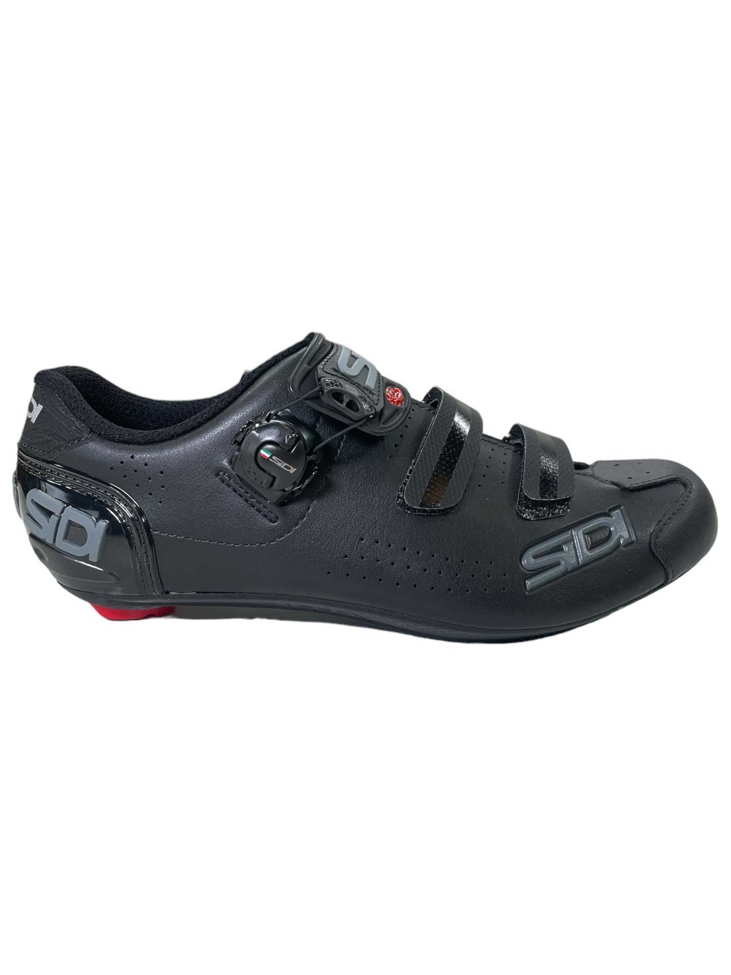 The Sidi Men's Alba-2 Cycling Shoe is black with a carbon sole, ratchet buckle, two hook-and-loop straps, silver Sidi branding on the side, and a bold red heel detail.