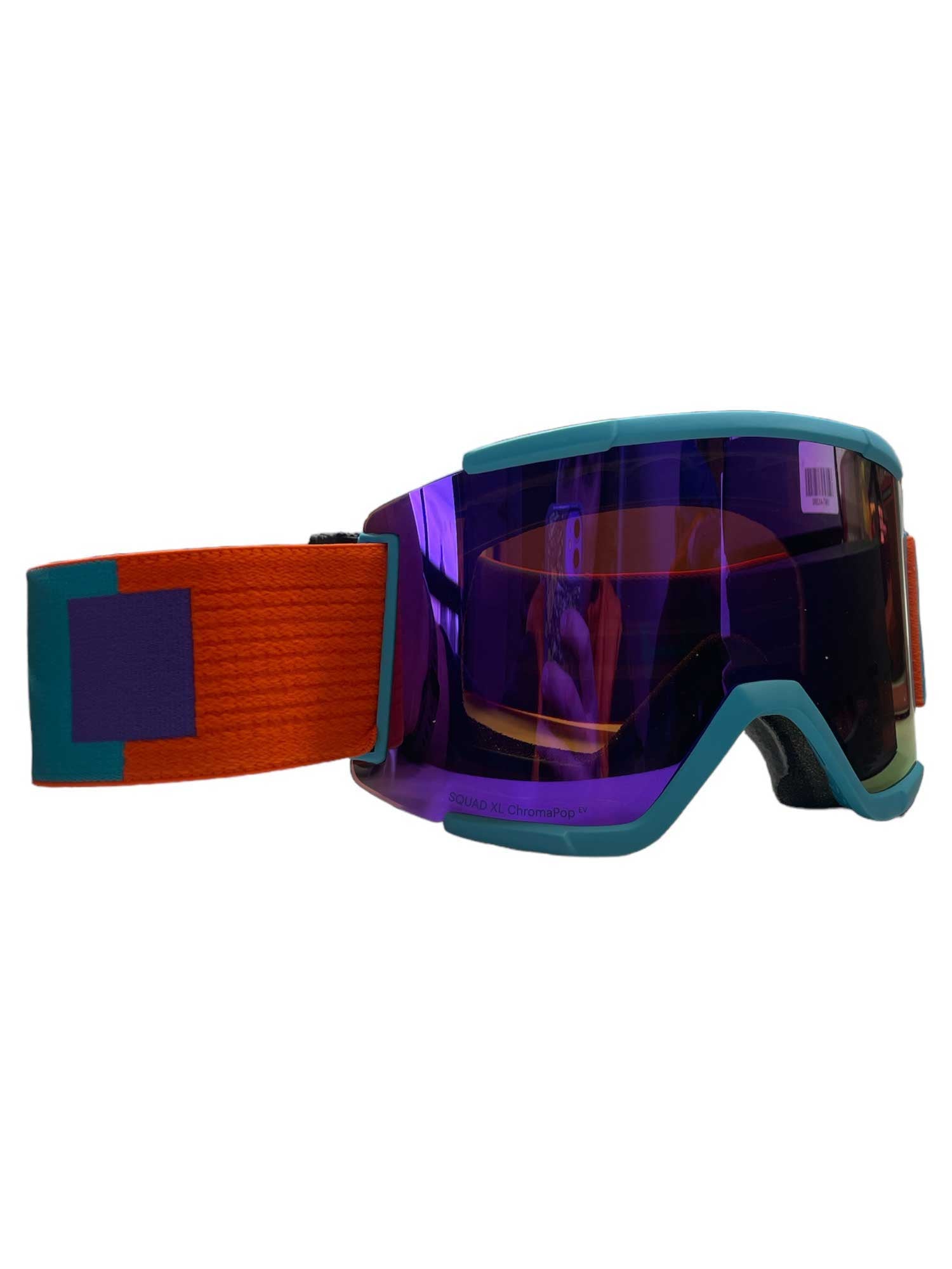 The Smith Squad XL Snow Goggle features a reflective purple ChromaPop lens, turquoise frame, and a wide orange strap with teal and purple geometric accents. An anti-fog coating keeps your vision clear on the slopes.