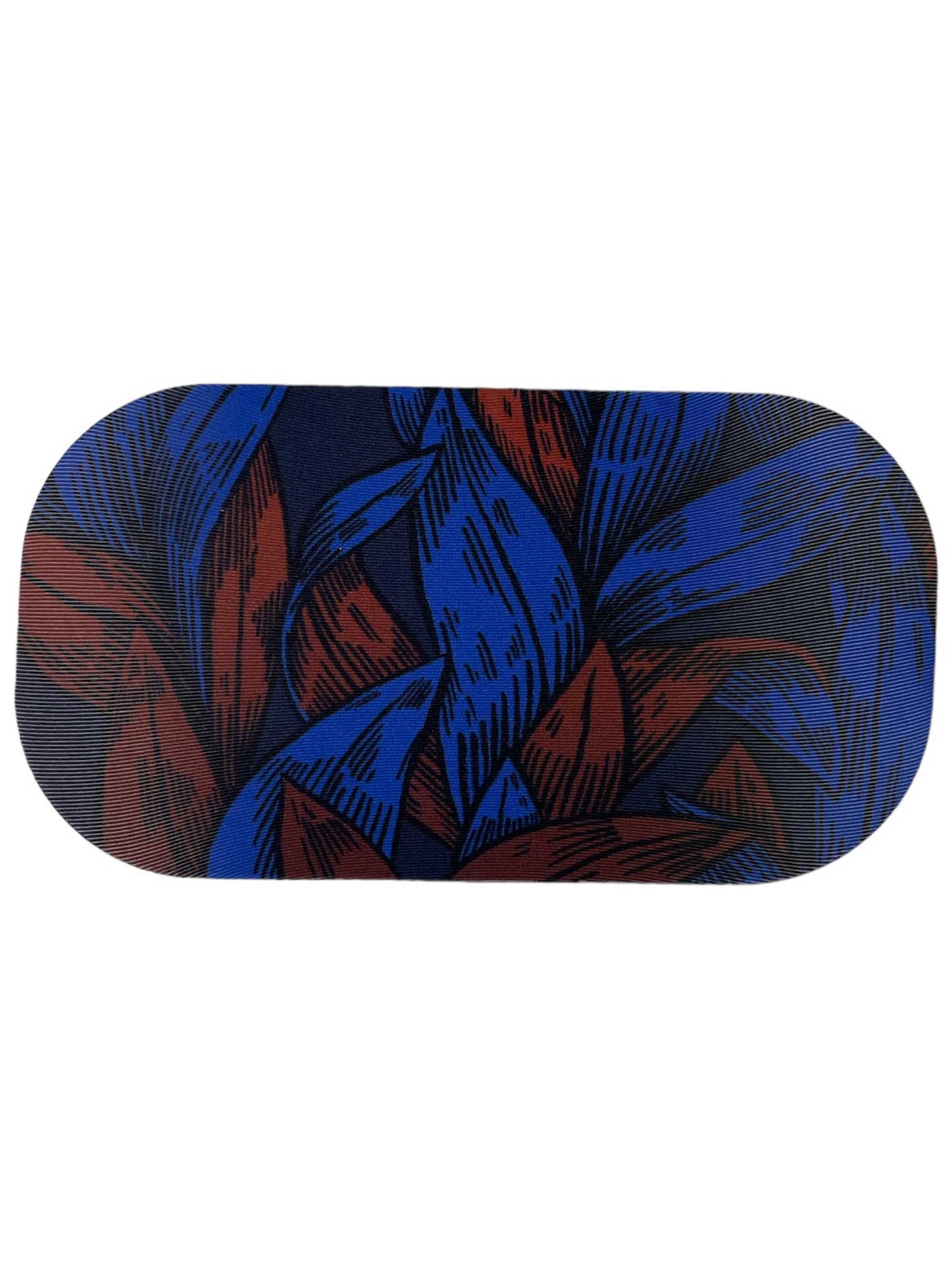 The GoggleSoc Protective Goggle Cover is an eco-friendly, oval cover with a striking graphic of overlapping blue and red leaves on a dark background.