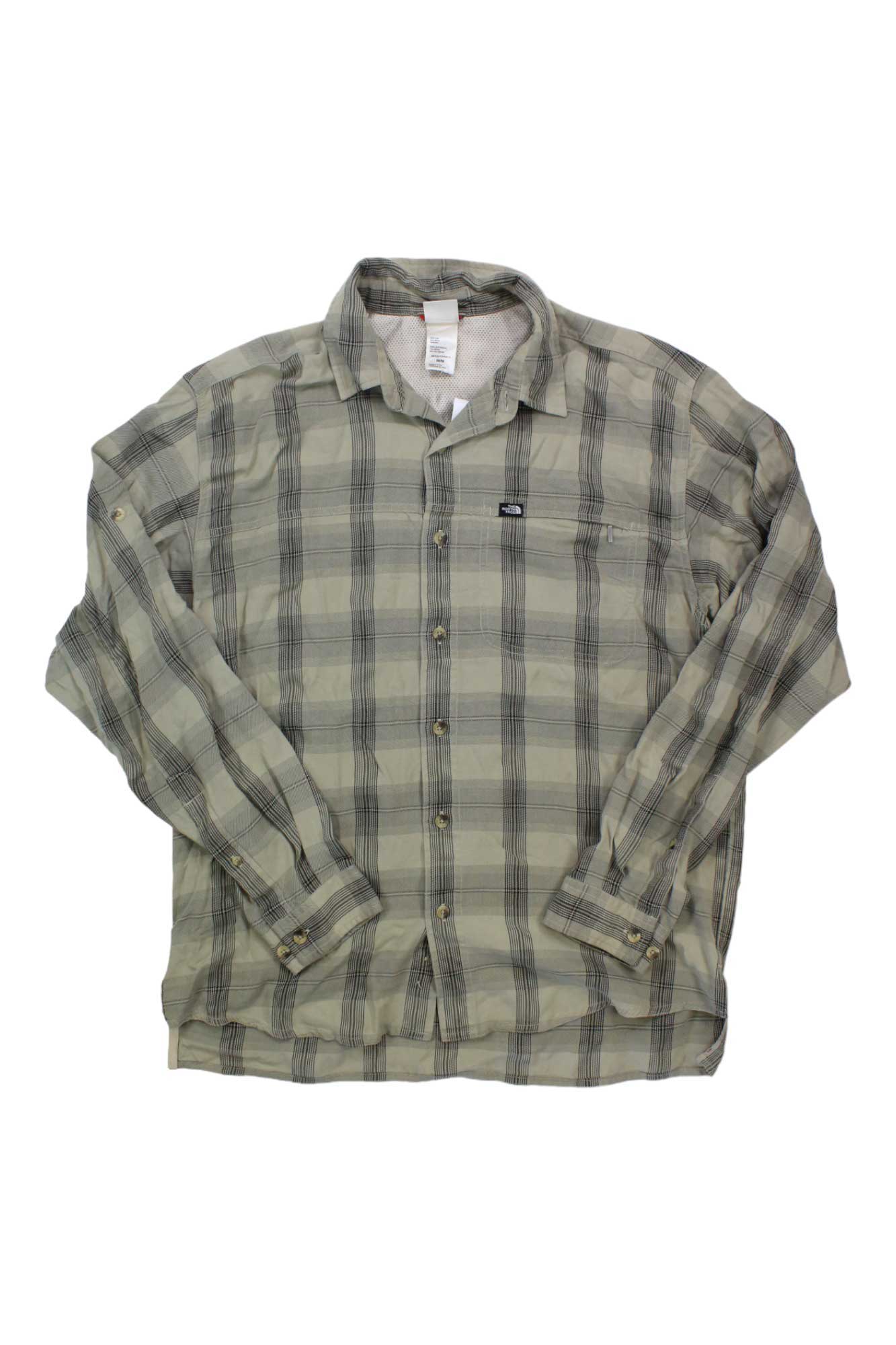 The North Face Men's Arroyo Lightweight Flannel Shirt features long sleeves, a button-up front, beige and gray plaid, a collar, chest pocket with tag, and is made from organic cotton with a slightly wrinkled look.