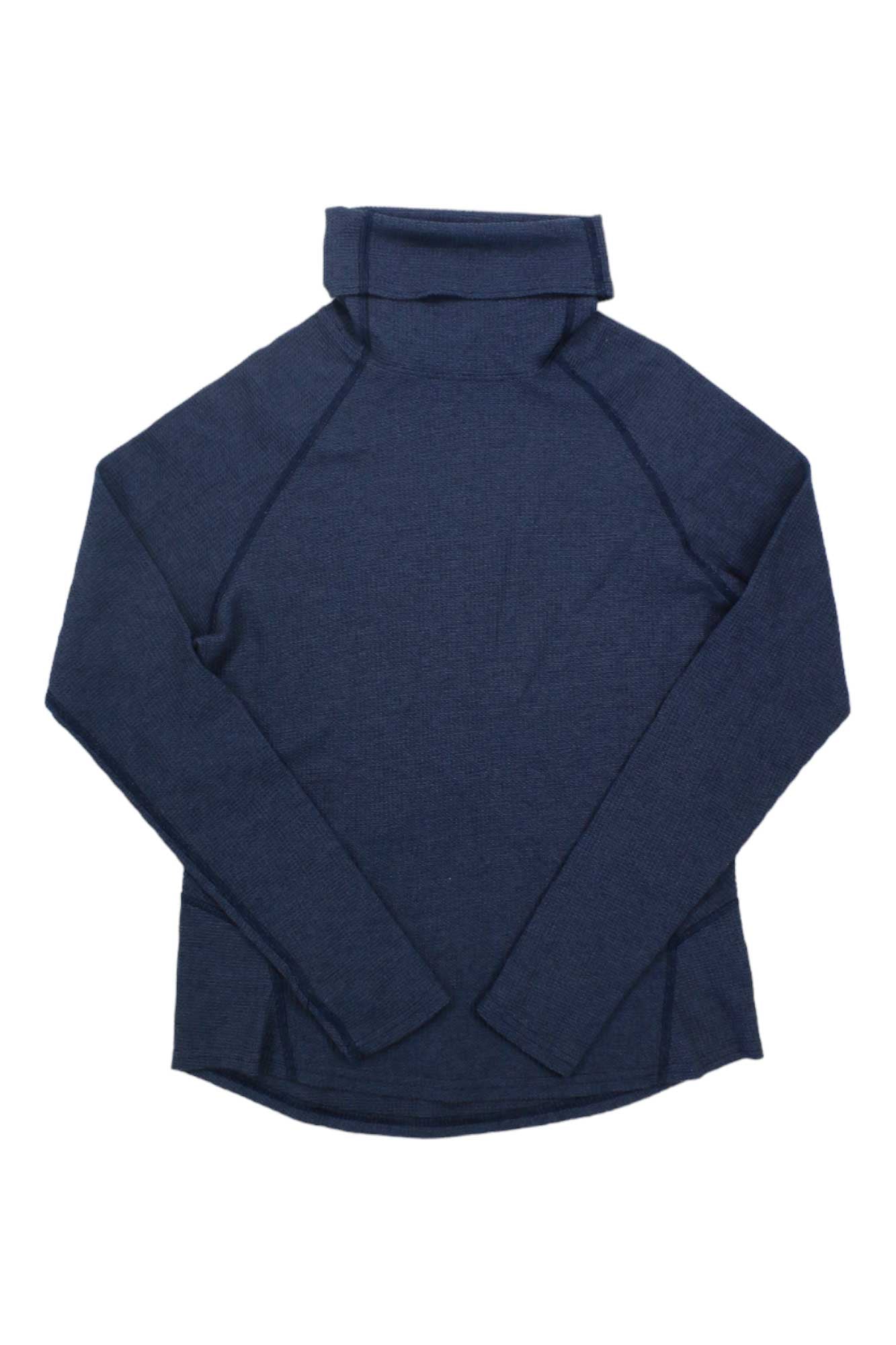 The Kuhl Womens Petra Turtleneck, a long-sleeve navy top with a waffle weave texture for breathable warmth, is shown laid flat on a white background.