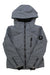 Obermeyer Girls Rayla Ski Jacket: Gray insulated winter jacket with hood, black zippers, front pockets, and a round patch on the left sleeve. Modern, structured ski jacket displayed against a white background.