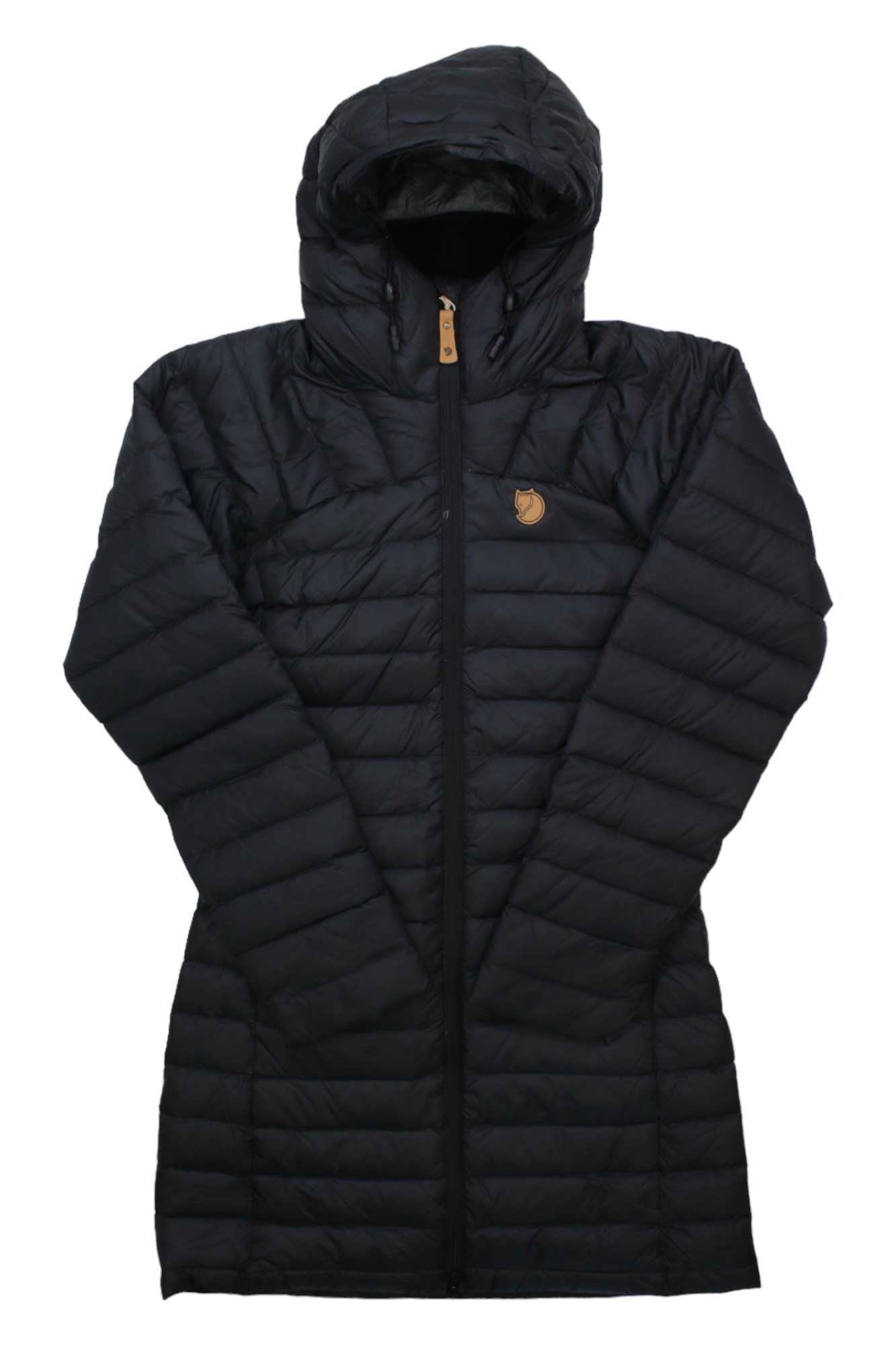 The Fjallraven Women's Snow Flake Parka is a long, black puffer jacket with horizontal quilting, front zipper, adjustable hood, and a small brown logo patch on the left chest.