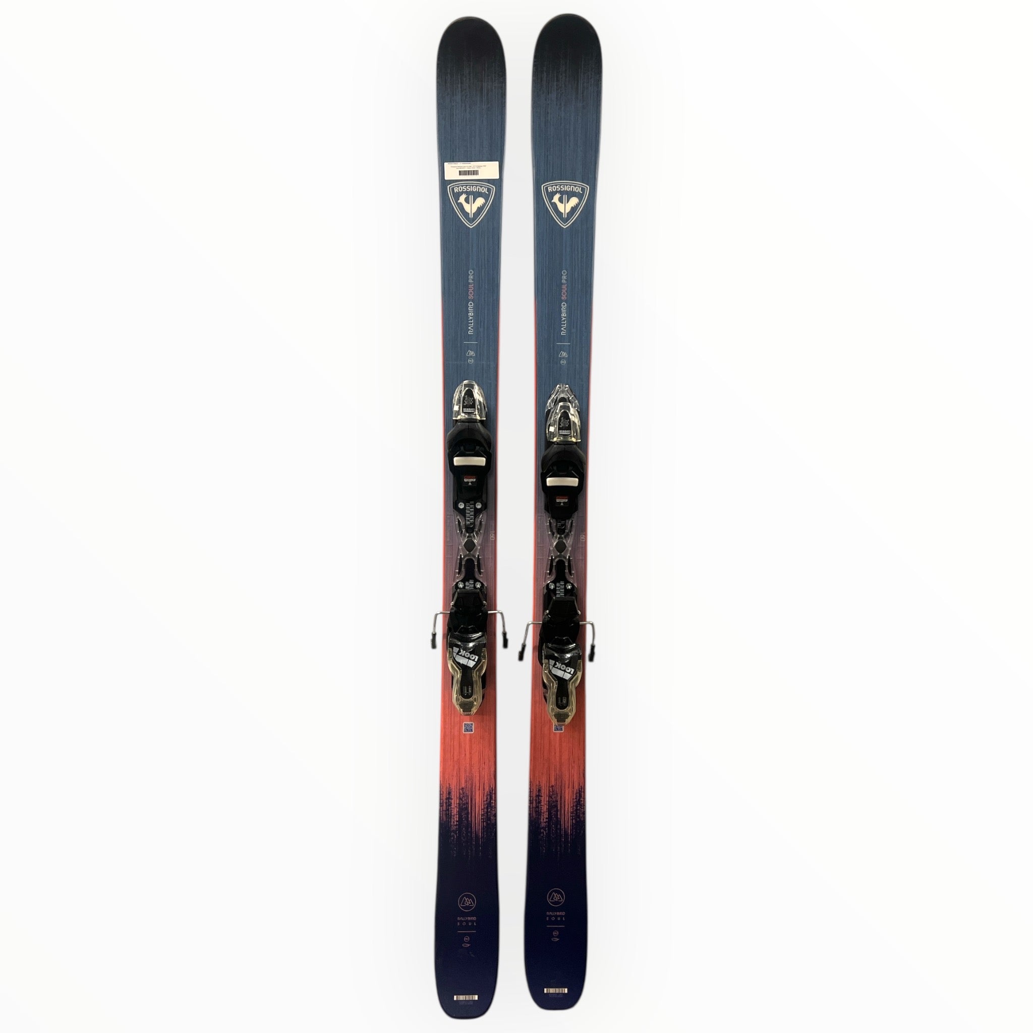 A pair of Rossignol Rallybird Soul Pro Skis + XPress 10 Bindings 2026, featuring a gradient from dark blue to reddish-orange, displayed vertically on a white background. Ideal for high-performance skiing.