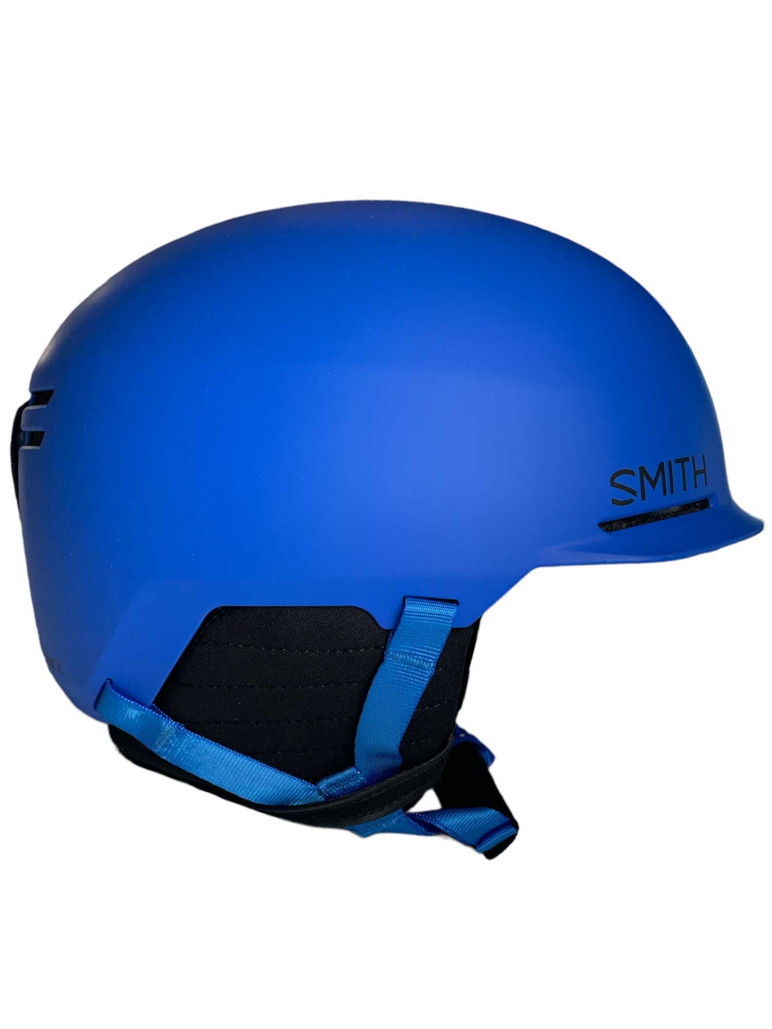 The Smith Juniors Scout MIPS Helmet is shown in side profile, featuring Bombshell construction, a matte blue finish, black inner padding, and an adjustable chin strap.