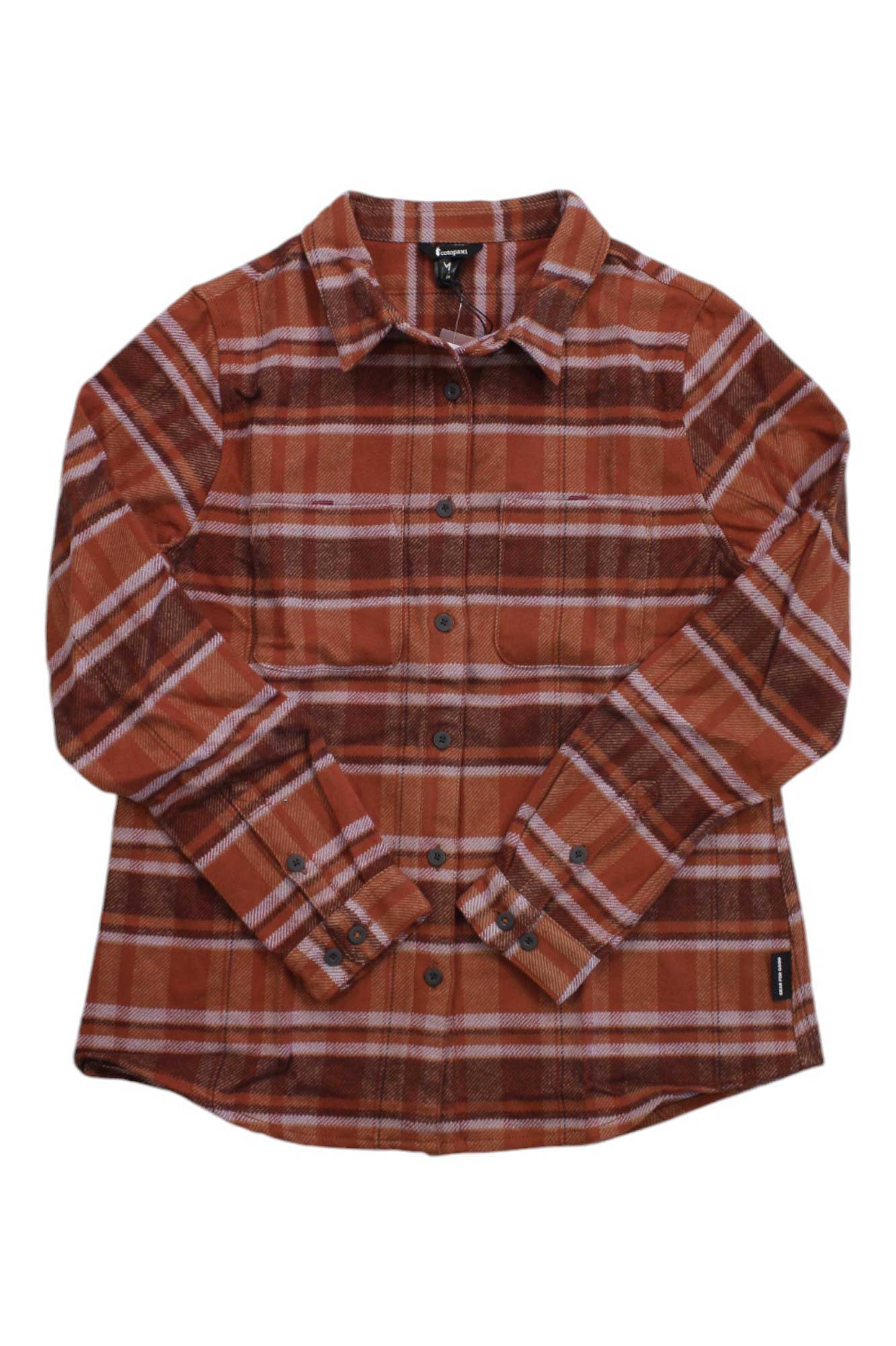 The Cotopaxi Womens Mero Flannel Shirt is a long-sleeve, button-up shirt made from organic cotton flannel, featuring a red, orange, and white plaid pattern, a collar, and a front chest pocket.