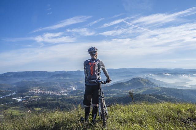 mountain biker looking at rolling hills