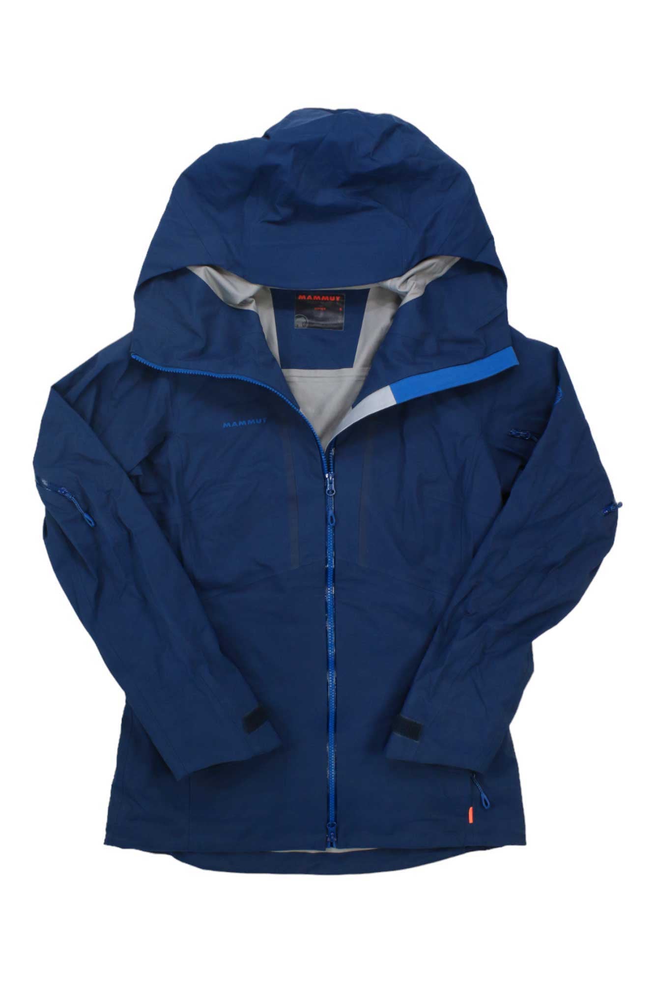 The Mammut Womens Haldigrat HS Hooded Jacket is a blue freeride hardshell with front zipper, adjustable cuffs, high collar, and visible brand label inside the neck plus stylish sleeve and chest zipper details for performance on the slopes.