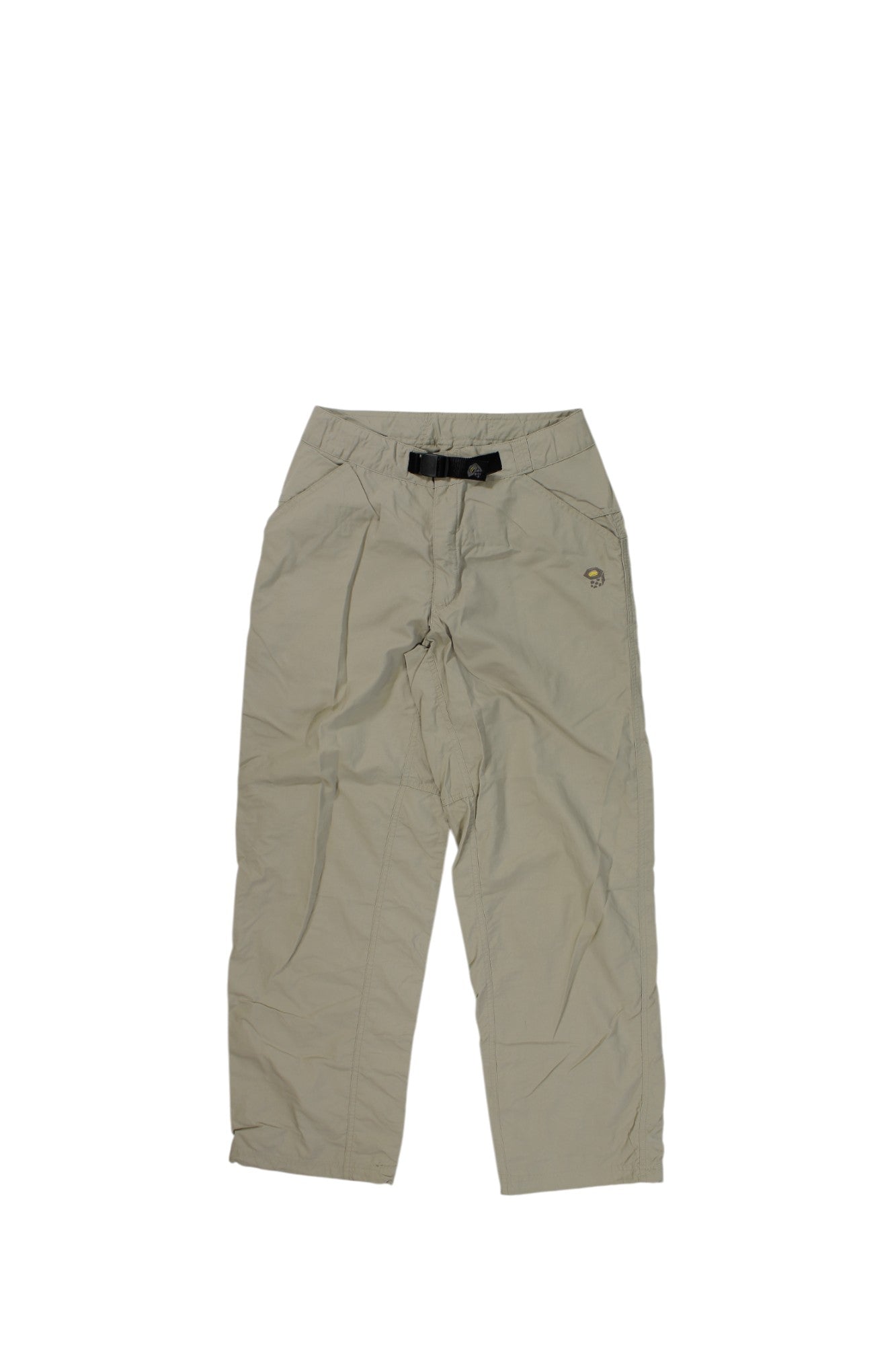 Mountain Hardwear Womens Belted Hiking Pants in beige, featuring a black belt, relaxed fit, moisture-wicking fabric, and convenient side waist pockets. Shown flat on a white background.