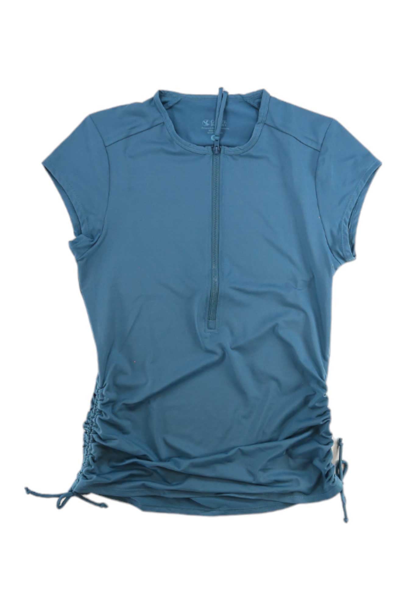 Carve Designs Women's Dawson Rashguard: blue short-sleeve athletic swim top with front half-zip and side drawstrings, laid flat on a white background. UPF 50+ sun protection—ideal for outdoor activities.
