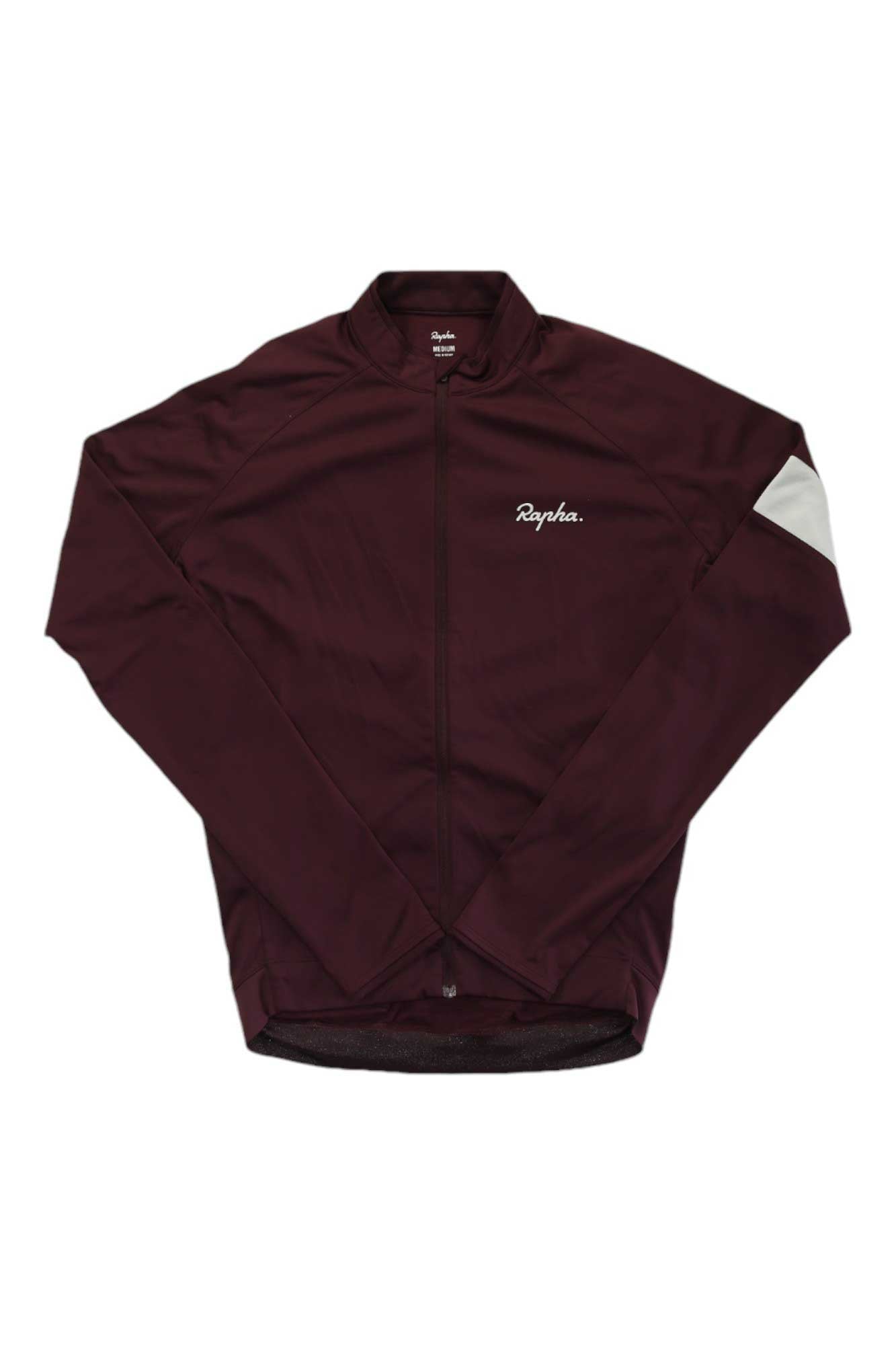 The Rapha Mens Core Long Sleeve Jersey in maroon features a front zipper, moisture-wicking fabric, a white Rapha logo on the chest, and a single white armband on the left sleeve, shown laid flat on a white background.
