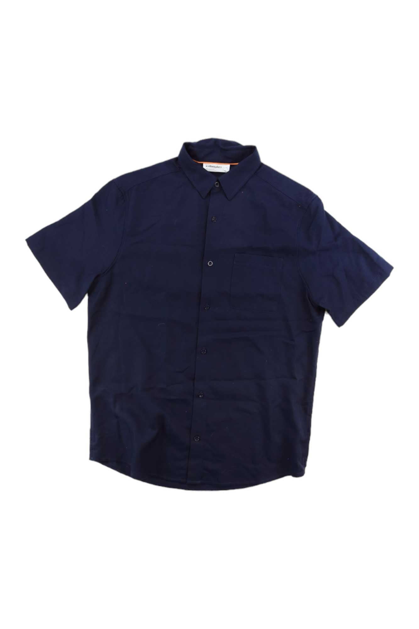 The Icebreaker Mens Steveston SS Shirt is a navy blue, short-sleeve, collared shirt with a chest pocket. Made from moisture-wicking fabric, it’s displayed against a white background.