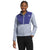 A woman stands smiling with one hand in her pocket, wearing The North Face Women's Antora Triclimate Jacket—a light blue and purple zip-up fleece with recycled nylon and the logo—against a white background.