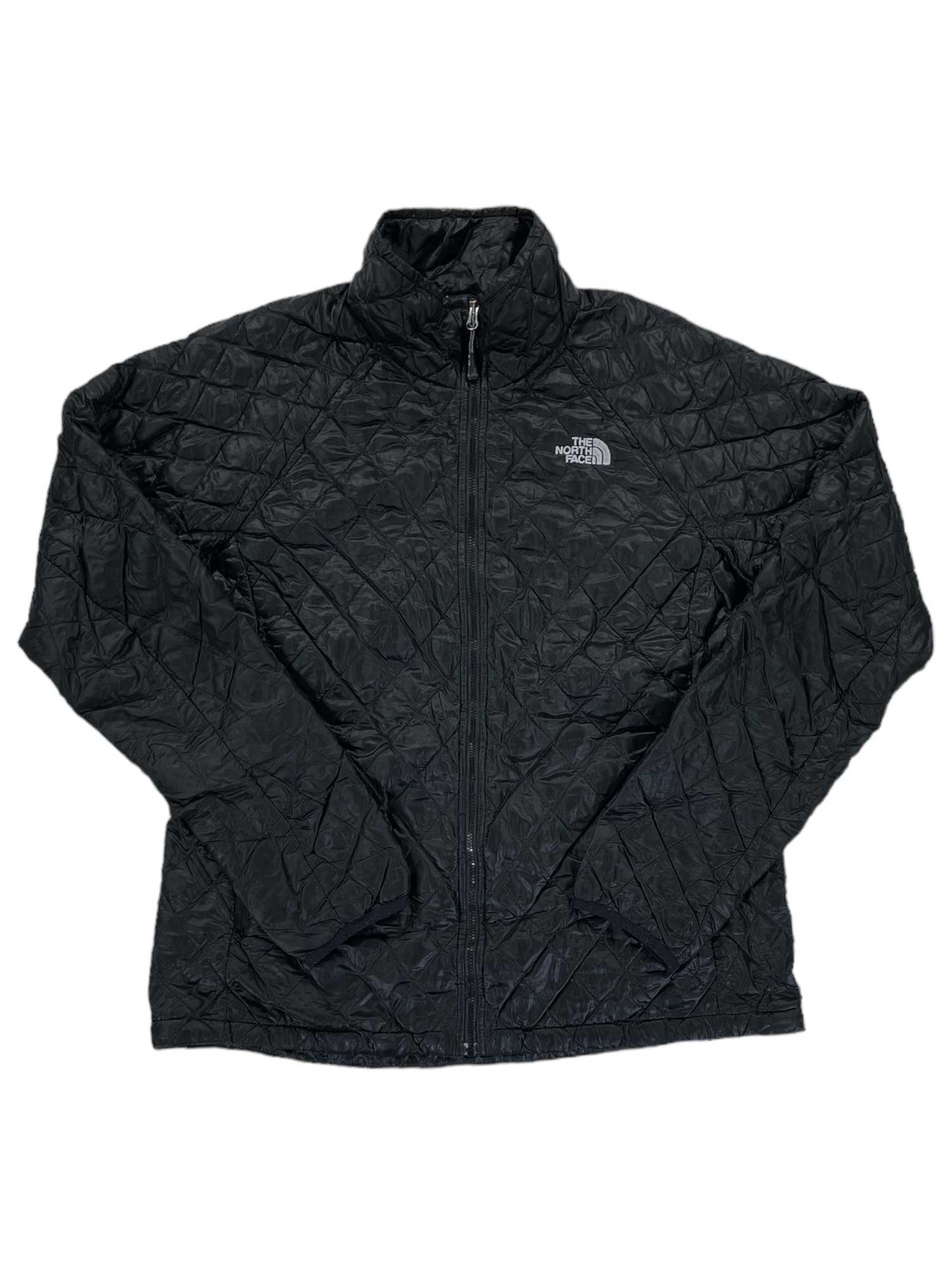 A black Women's ThermoBall Full-Zip Jacket by The North Face, featuring synthetic insulation, a stand-up collar, and a white logo on the left chest. The jacket is shown laid flat with sleeves slightly spread outward.