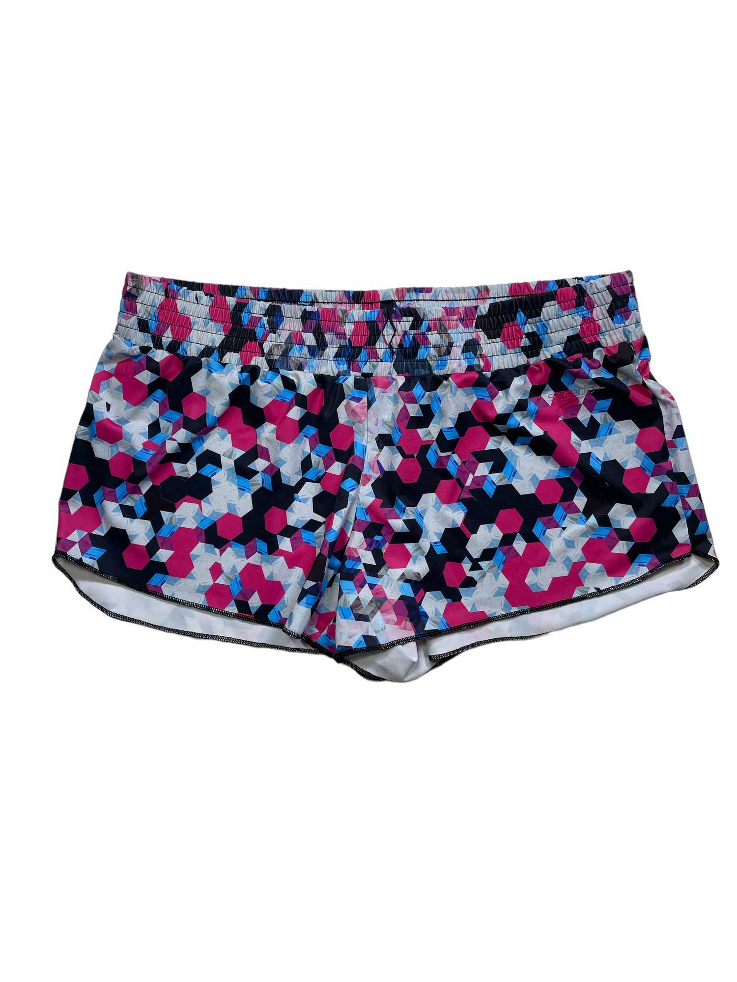 The Speedo Womens Printed Coverup Short features a pink, blue, navy, and white geometric pattern, an elastic waistband, and UPF 50+ sun protection—ideal for active days or as a stylish swim coverup.