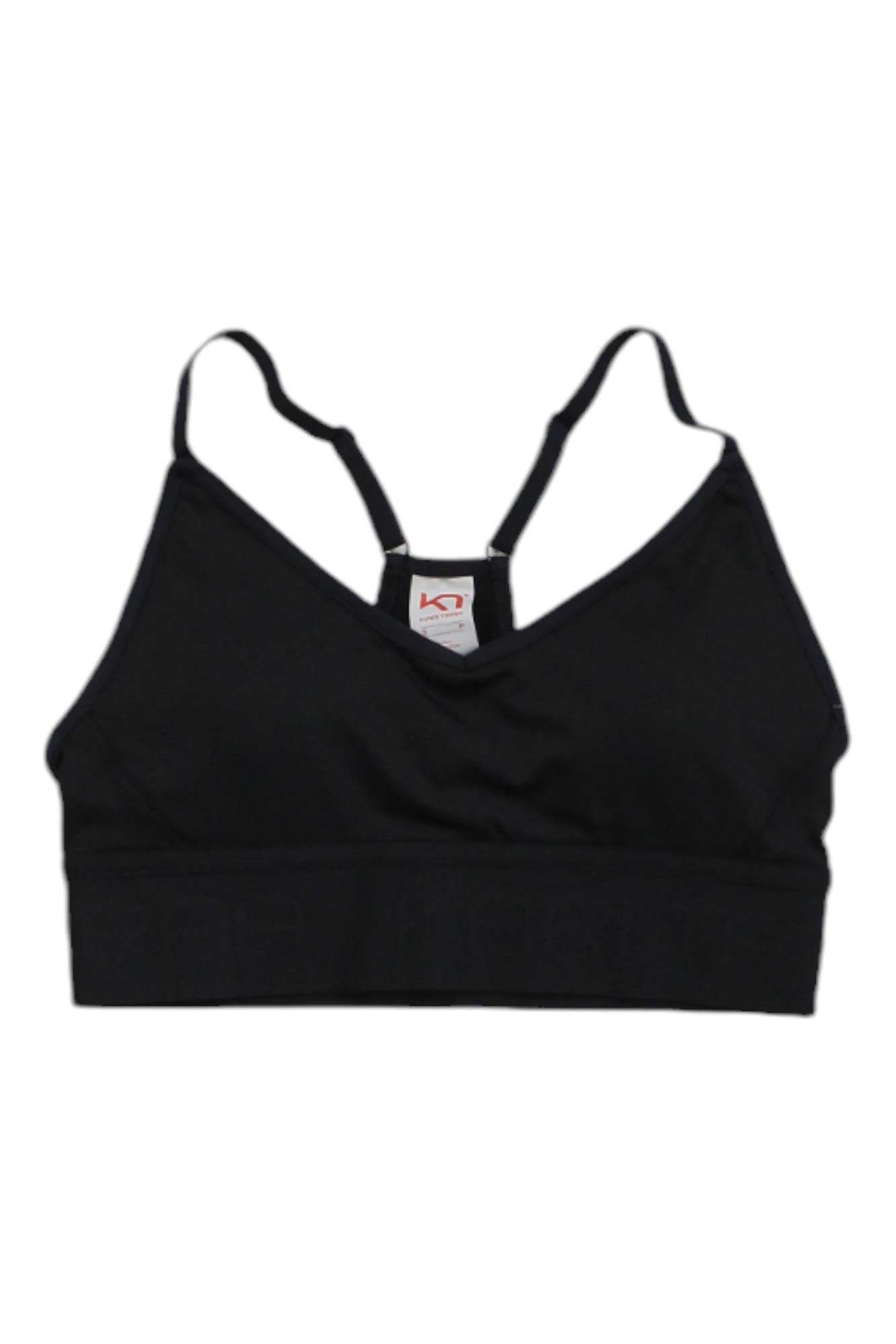 The Kari Traa Womens Var Bra is a black compression sports bra with adjustable straps and a small white tag at the center neckline, shown on a plain white background.