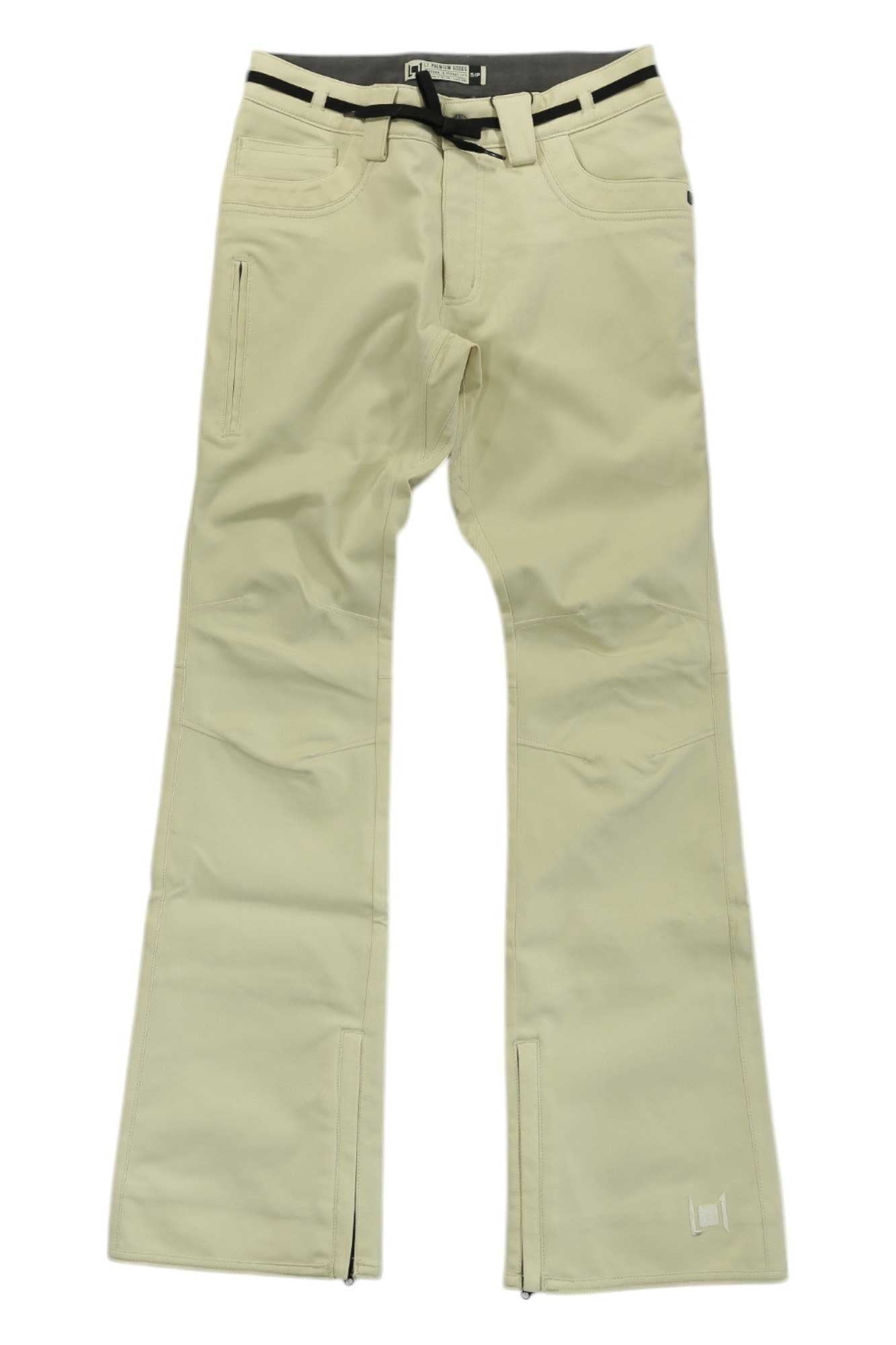 The L1 Womens Heartbreaker Twill Pant is a pair of beige snow pants with belt loops, front pockets, a black belt, slight flare at the bottom, and zippers near the cuffs.