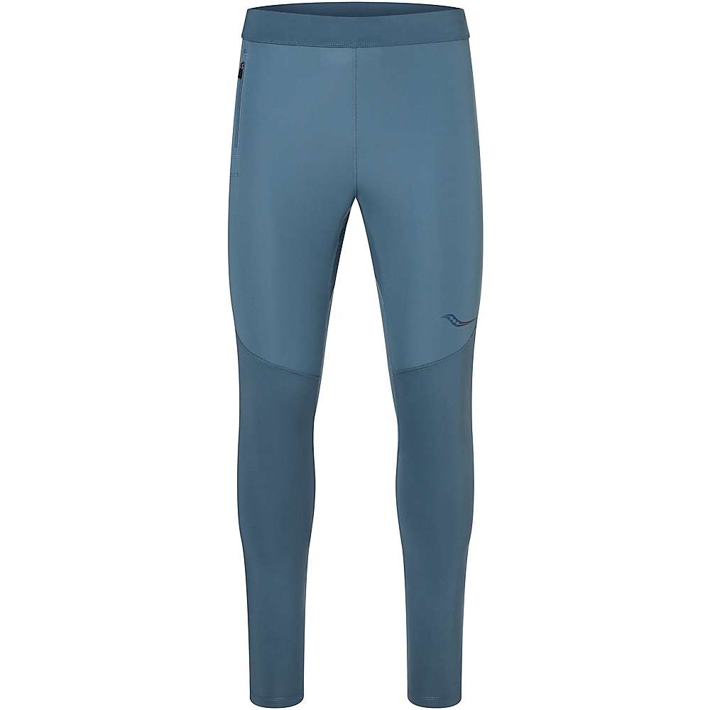 The Saucony Mens Runshield Tight is a blue, full-length men's running tight featuring a subtle logo on the left thigh and a small zippered pocket on the right hip, shown against a white background.